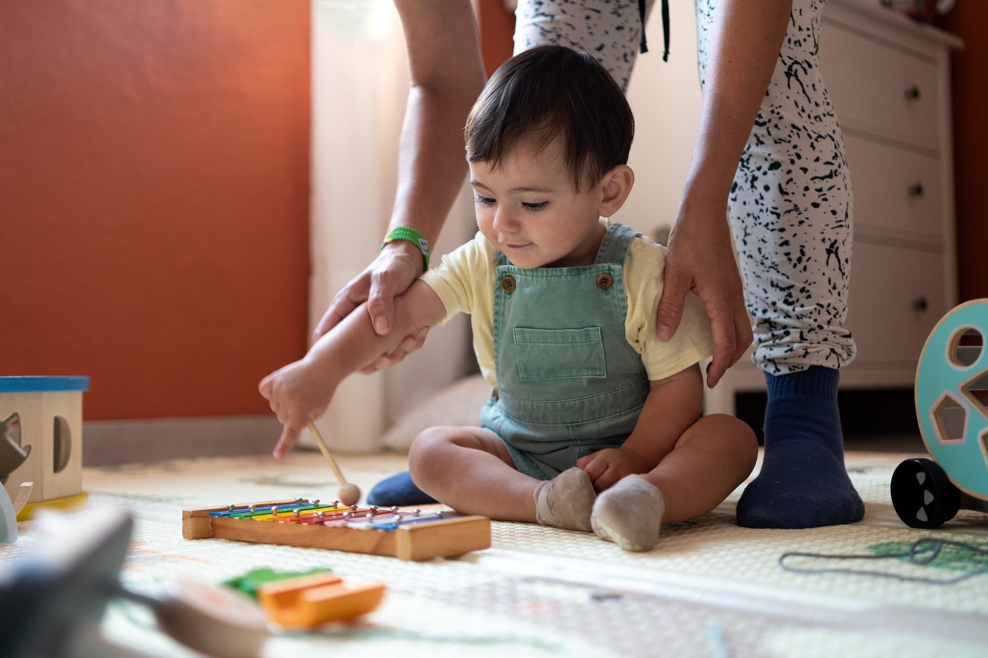 Baby playing at home with an instrument