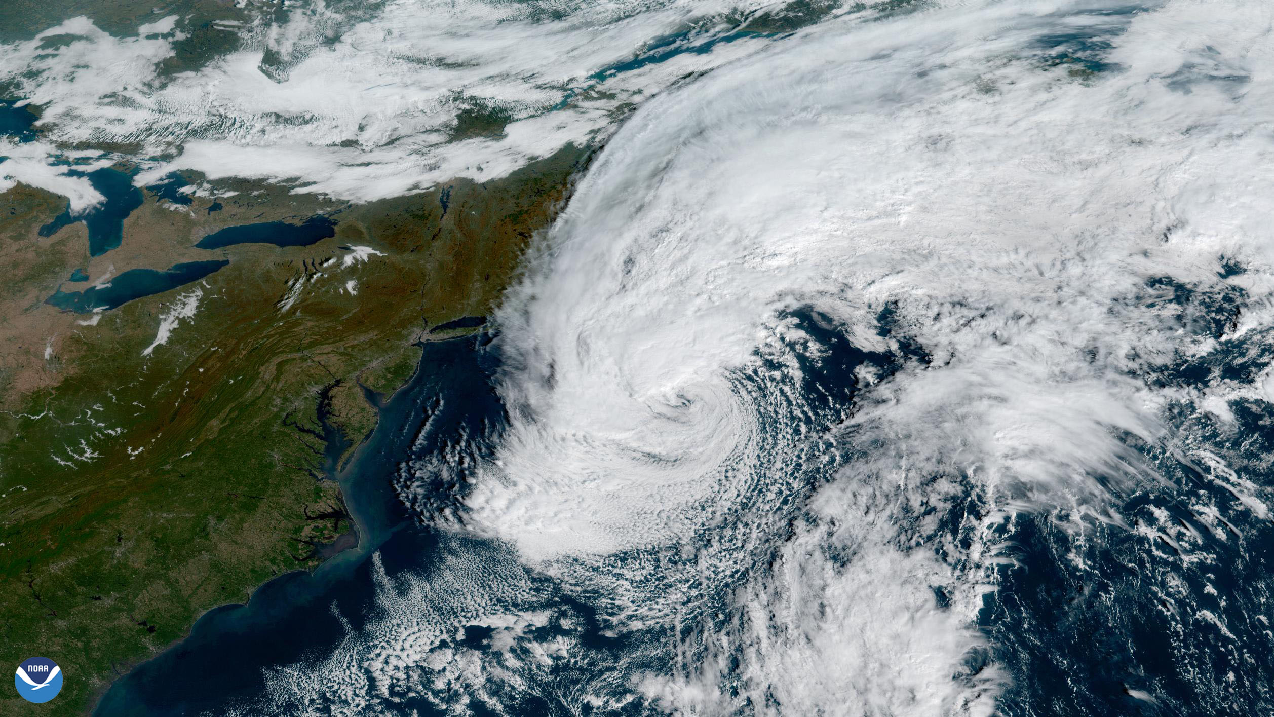 Satellite view of a swirling storm system over the Atlantic Ocean near the northeastern U.S. coastline.