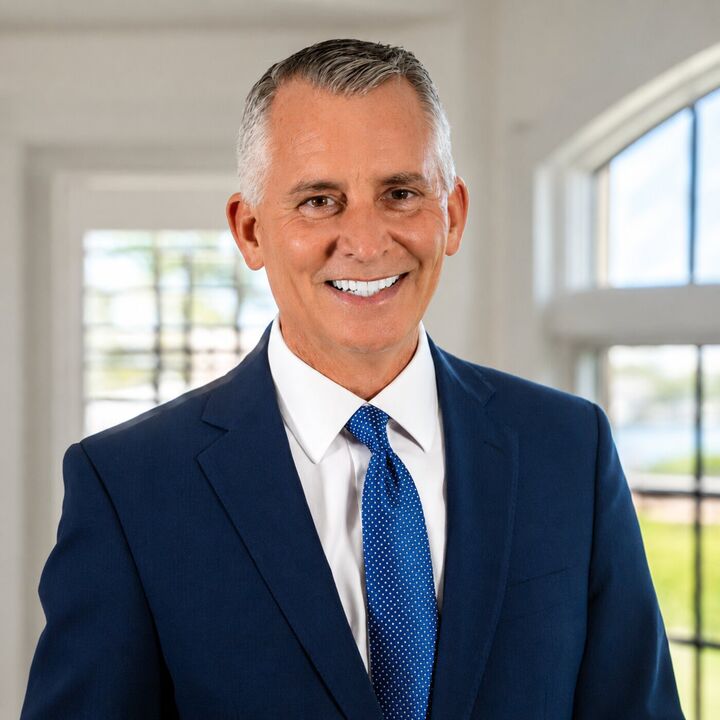 David Jolly wearing a navy suit, white shirt and blue tie.