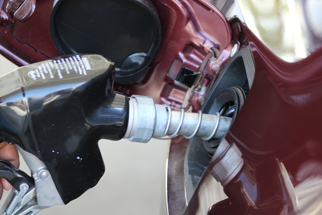 gas pump nozzle in a car's gas tank