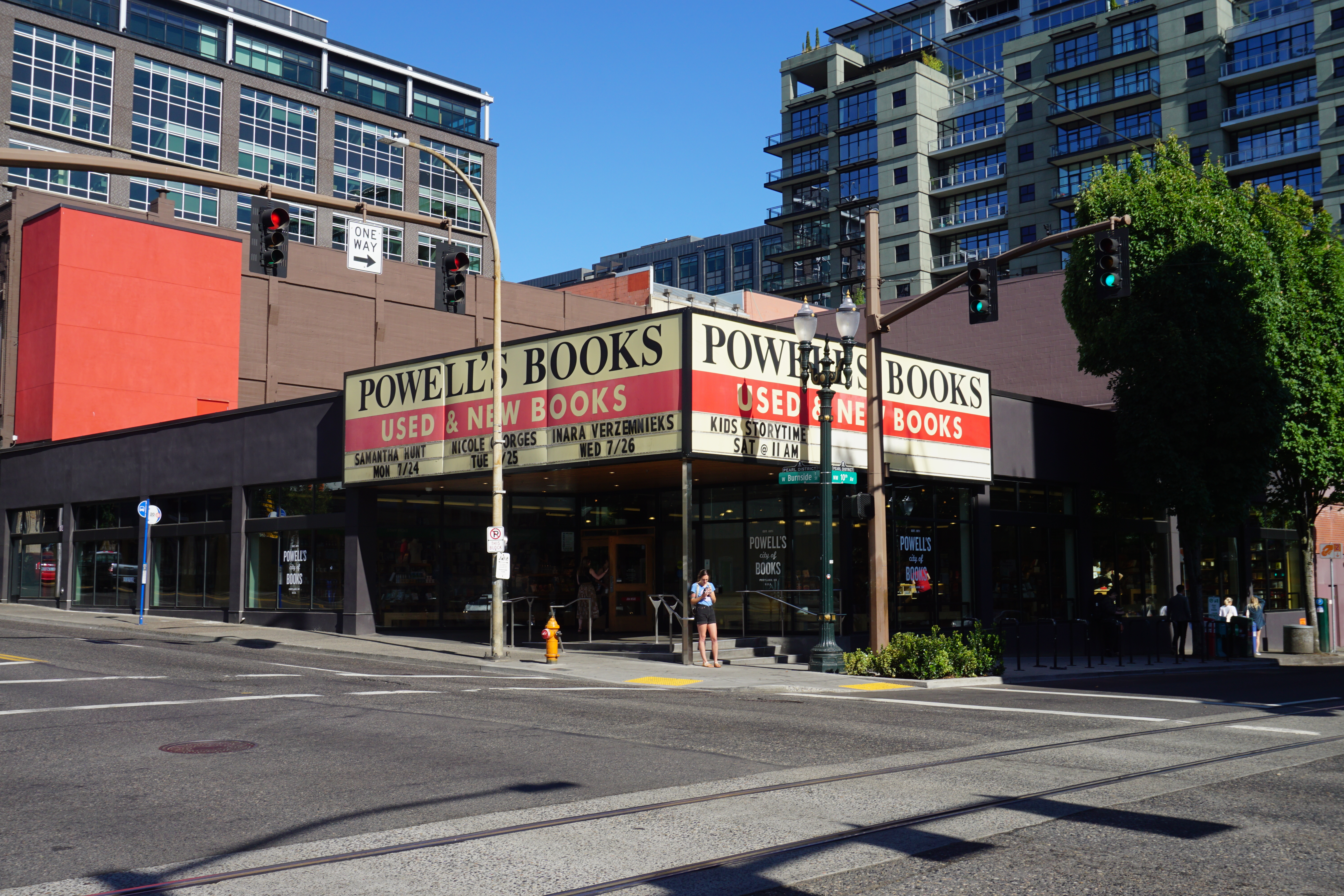Exterior of Powell's City of Books bookstore at a Portland street corner on a sunny day