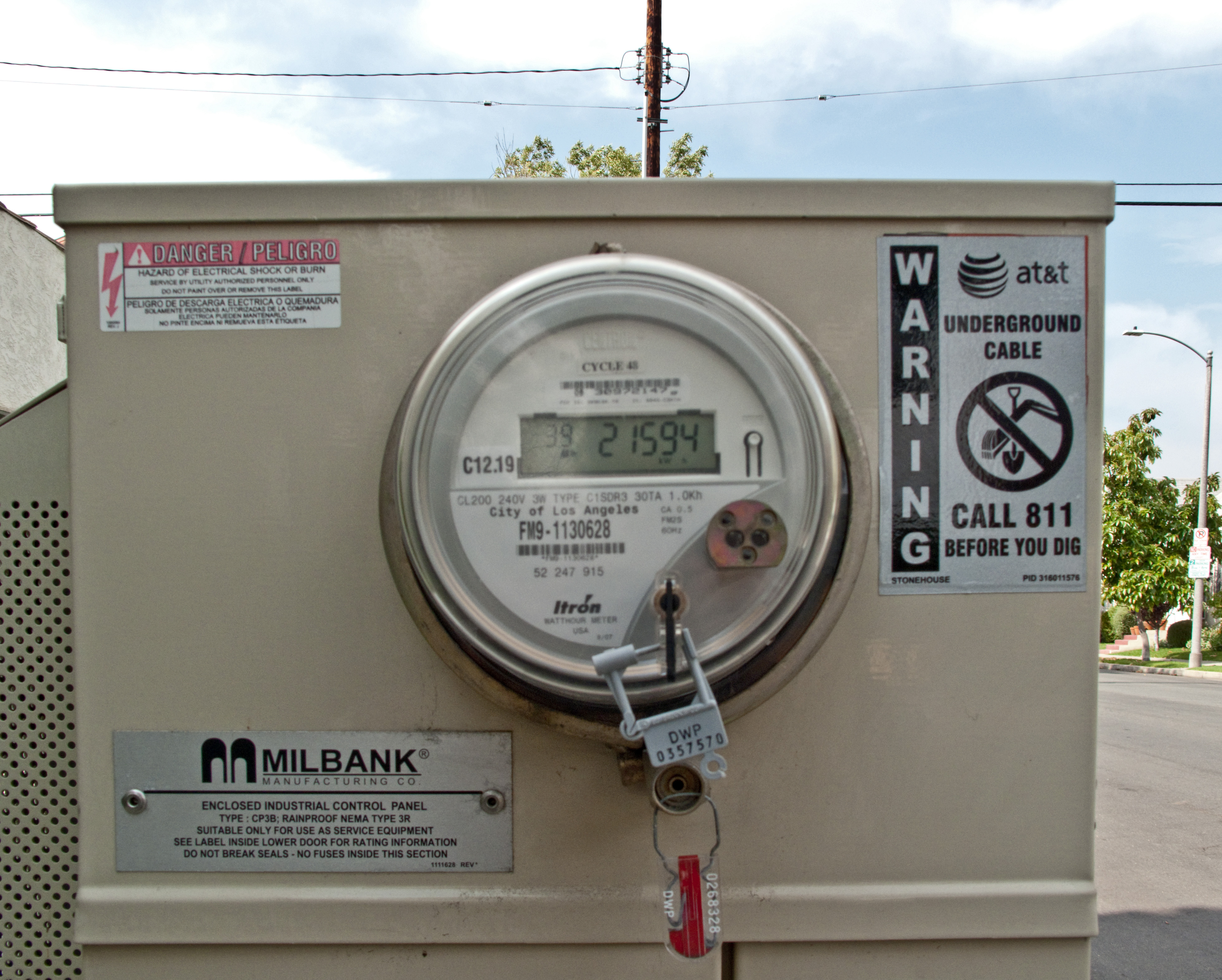 An LADWP electricity meter on a beige outdoor utility panel with a padlock.