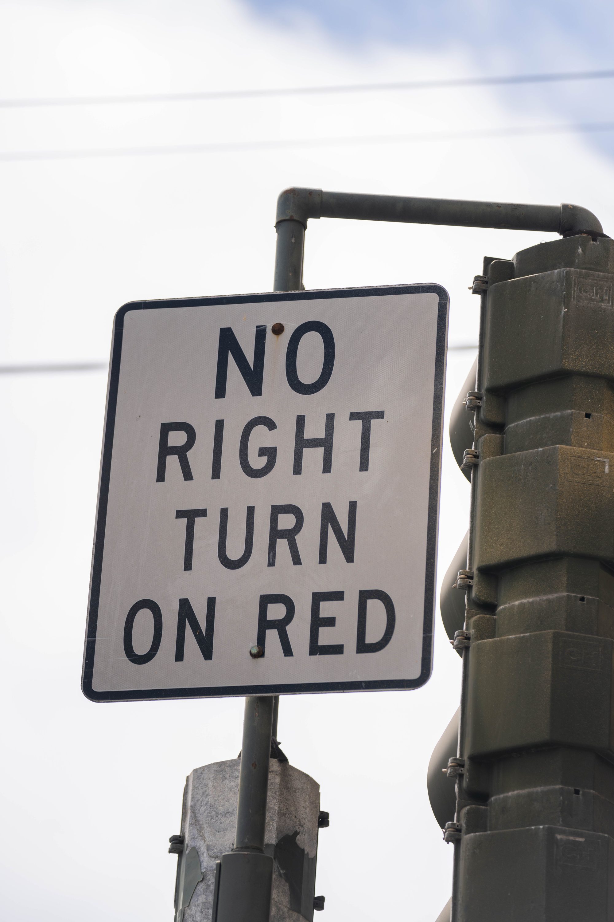 Traffic sign indicating no right turn on red signal, emphasizing road safety.