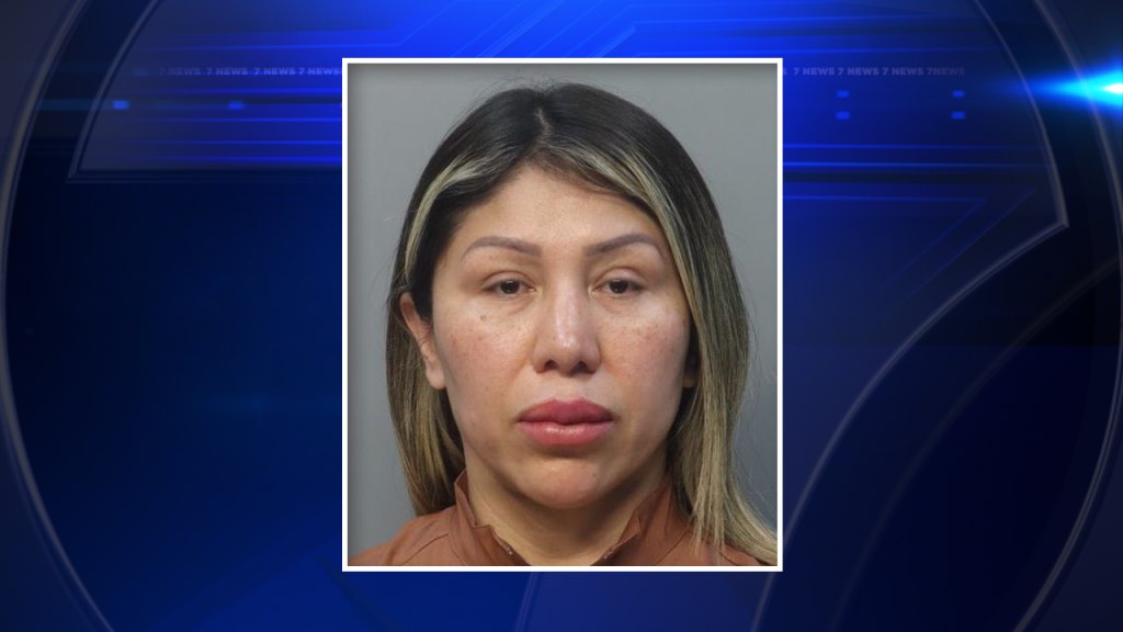 Booking photo of a woman with shoulder-length blonde-highlighted hair against a neutral background.