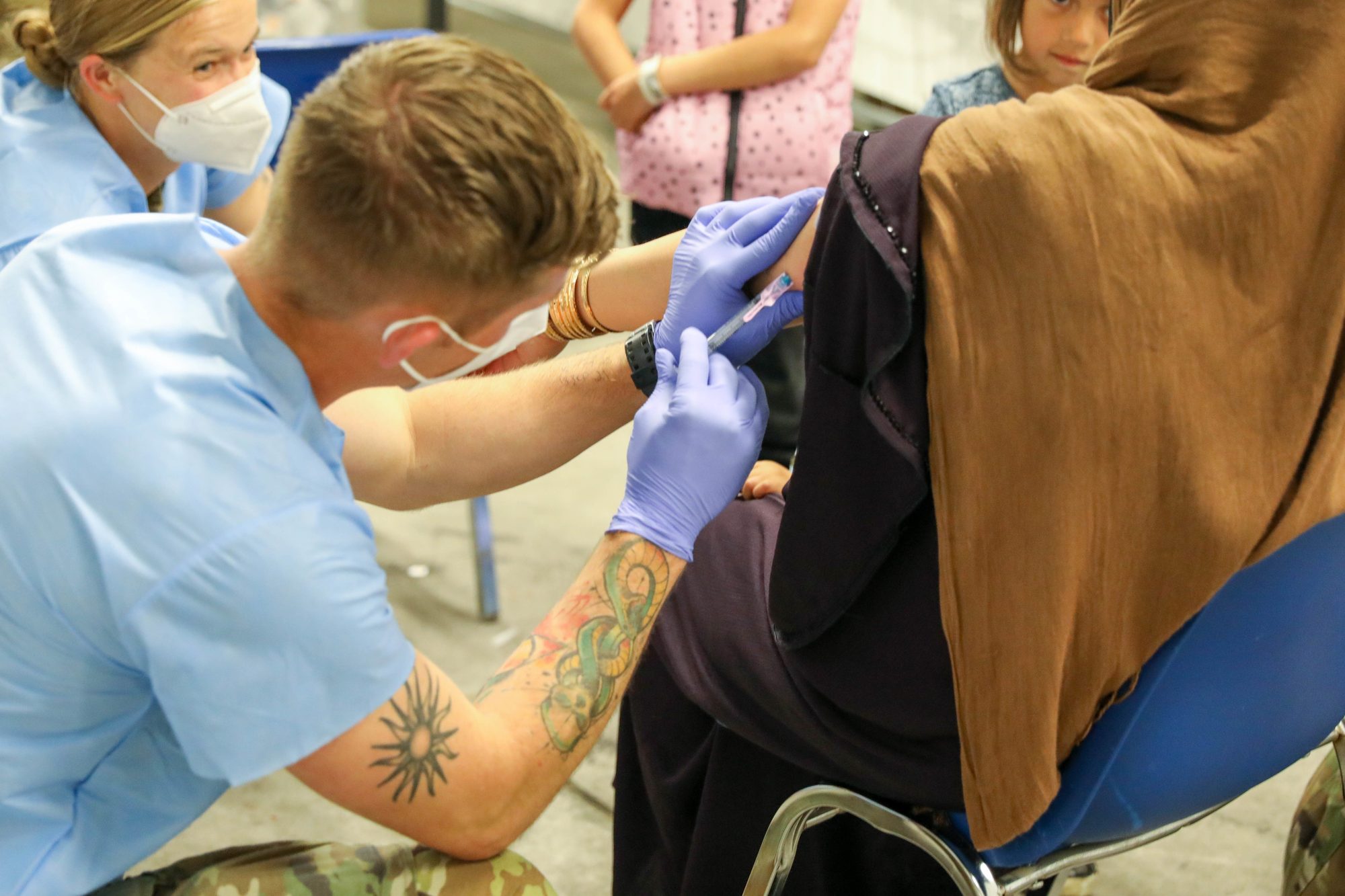 Afghan evacuees receive the Measles vaccine from 30th Medical Brigade, 21st Theater Sustainment Command personnel at Rhine Ordnance Barracks, Germany September 18, 2021.