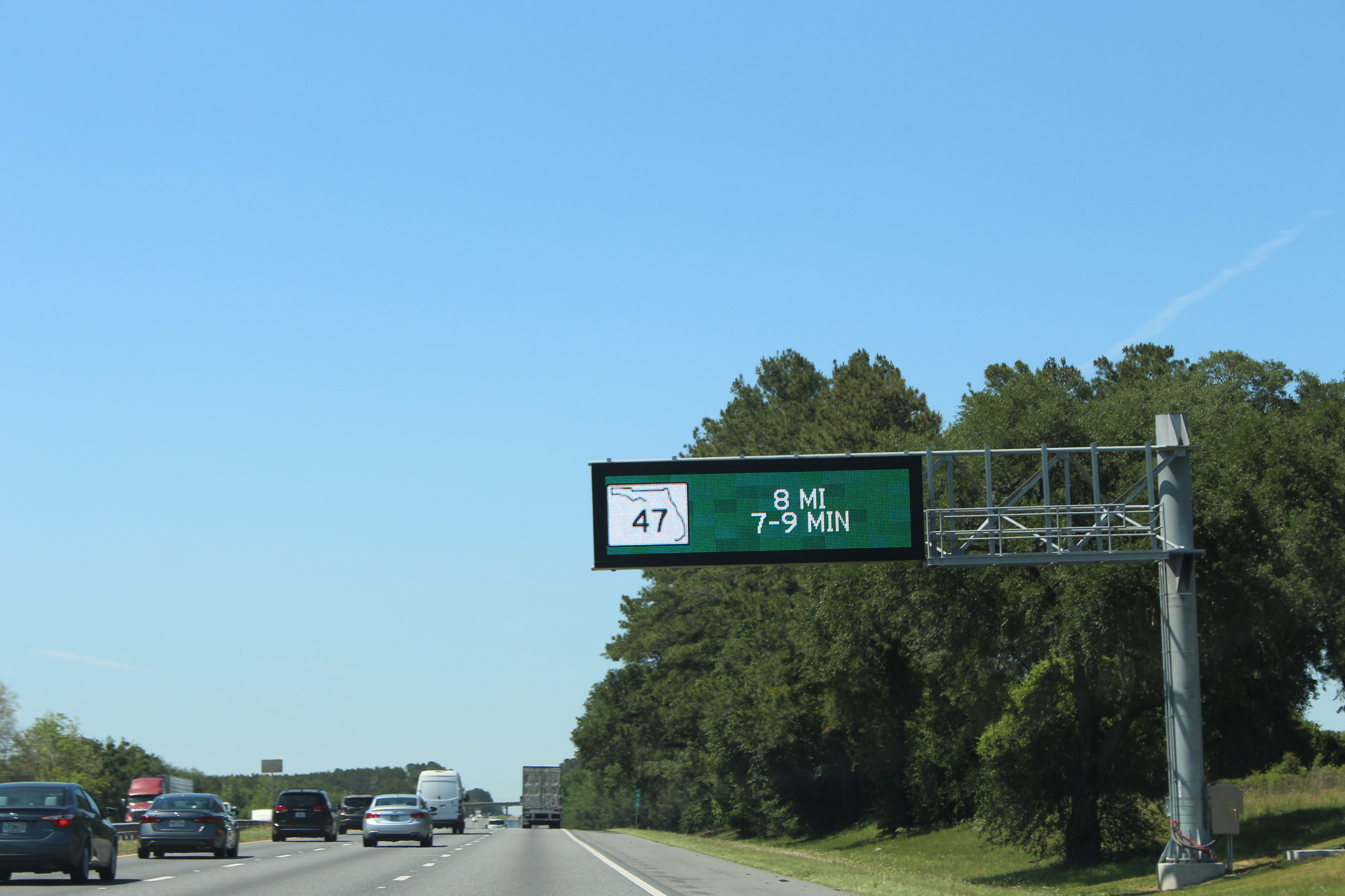Overhead electronic message sign spanning a multi-lane interstate highway.