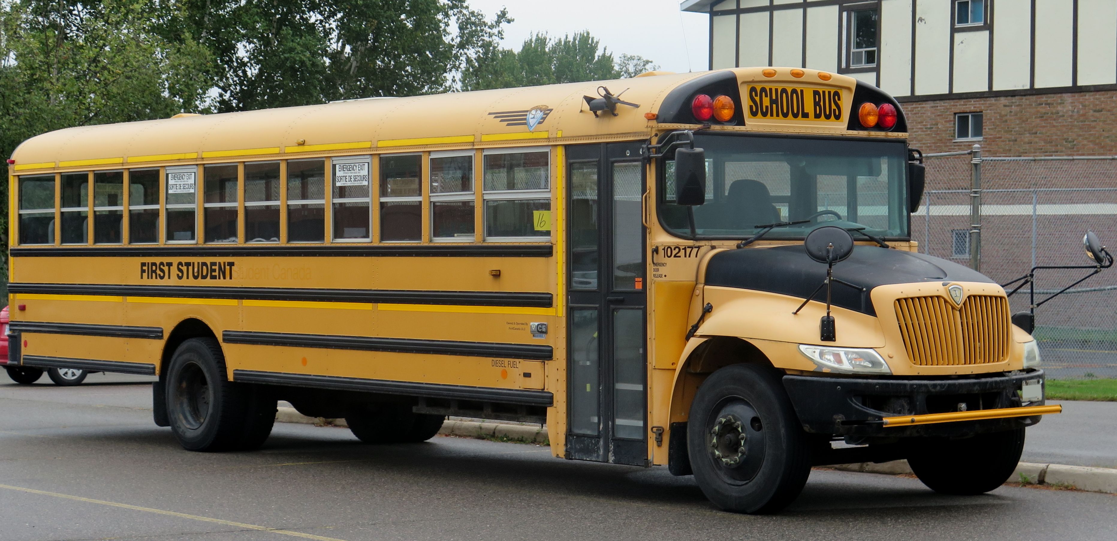 Yellow school bus seen from the front-right angle on a street.