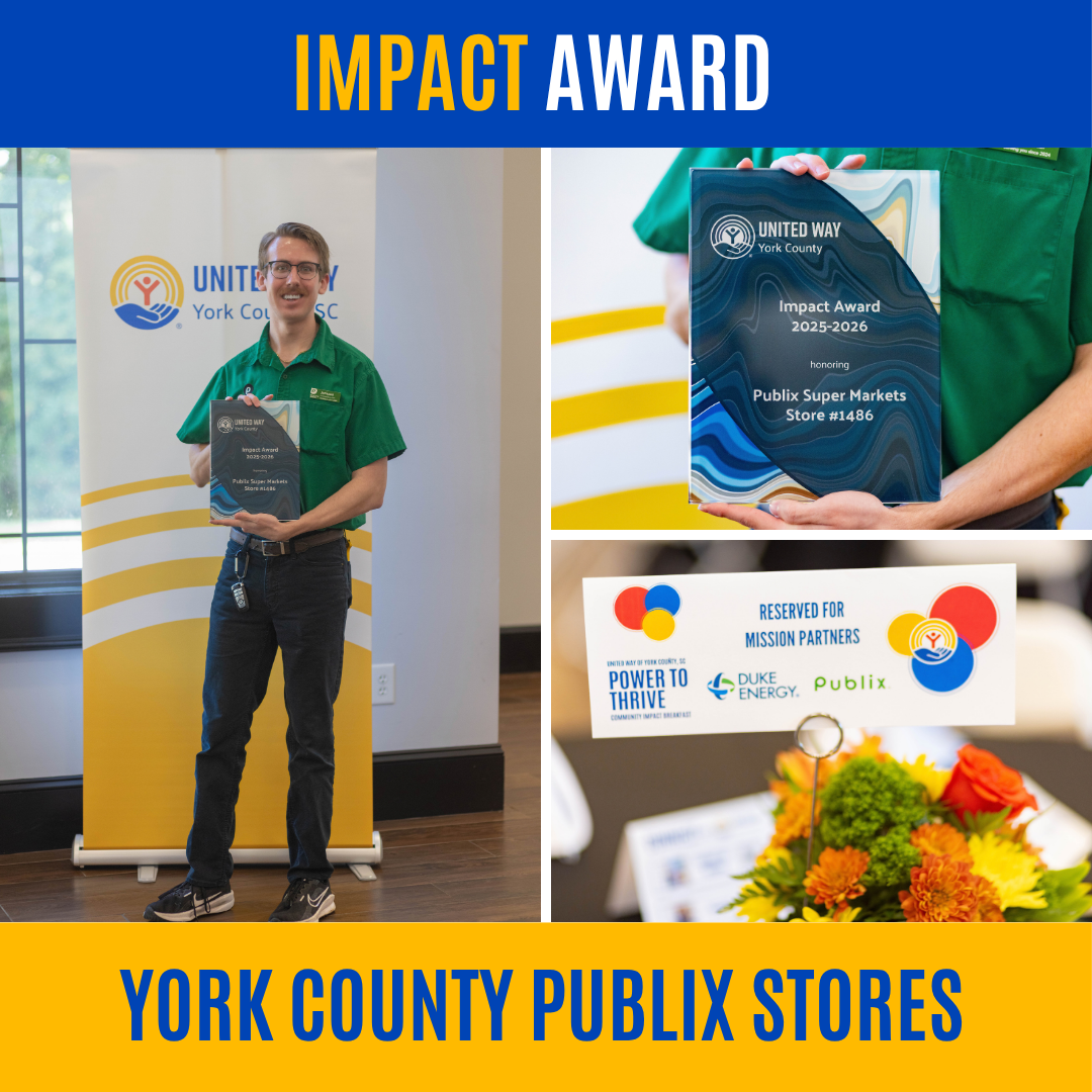 Person in green Publix uniform holding a glass award plaque at an indoor event.