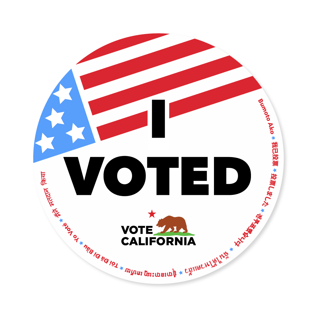 Circular 'I Voted' sticker featuring an American flag, bold text, and multilingual border text.