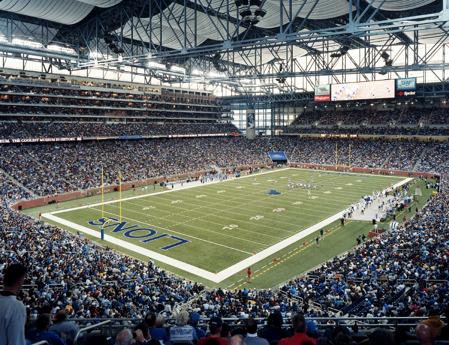 Interior of Ford Field stadium showing the full football field, end zones, and packed stands.
