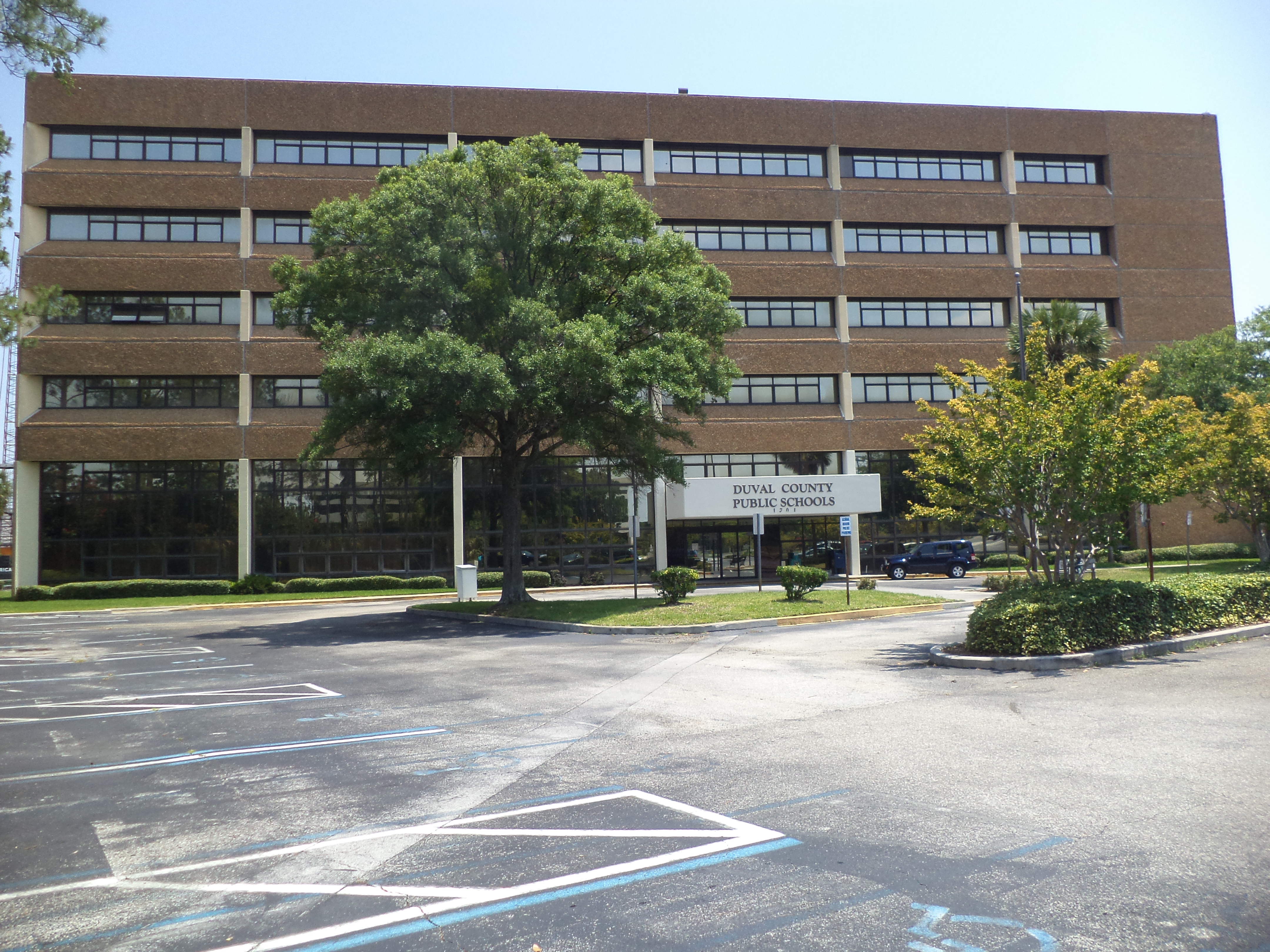 Multi-story brick building with a Duval County Public Schools sign at the entrance.