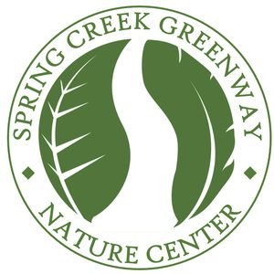 Circular green logo for Spring Creek Greenway Nature Center with two stylized leaves.