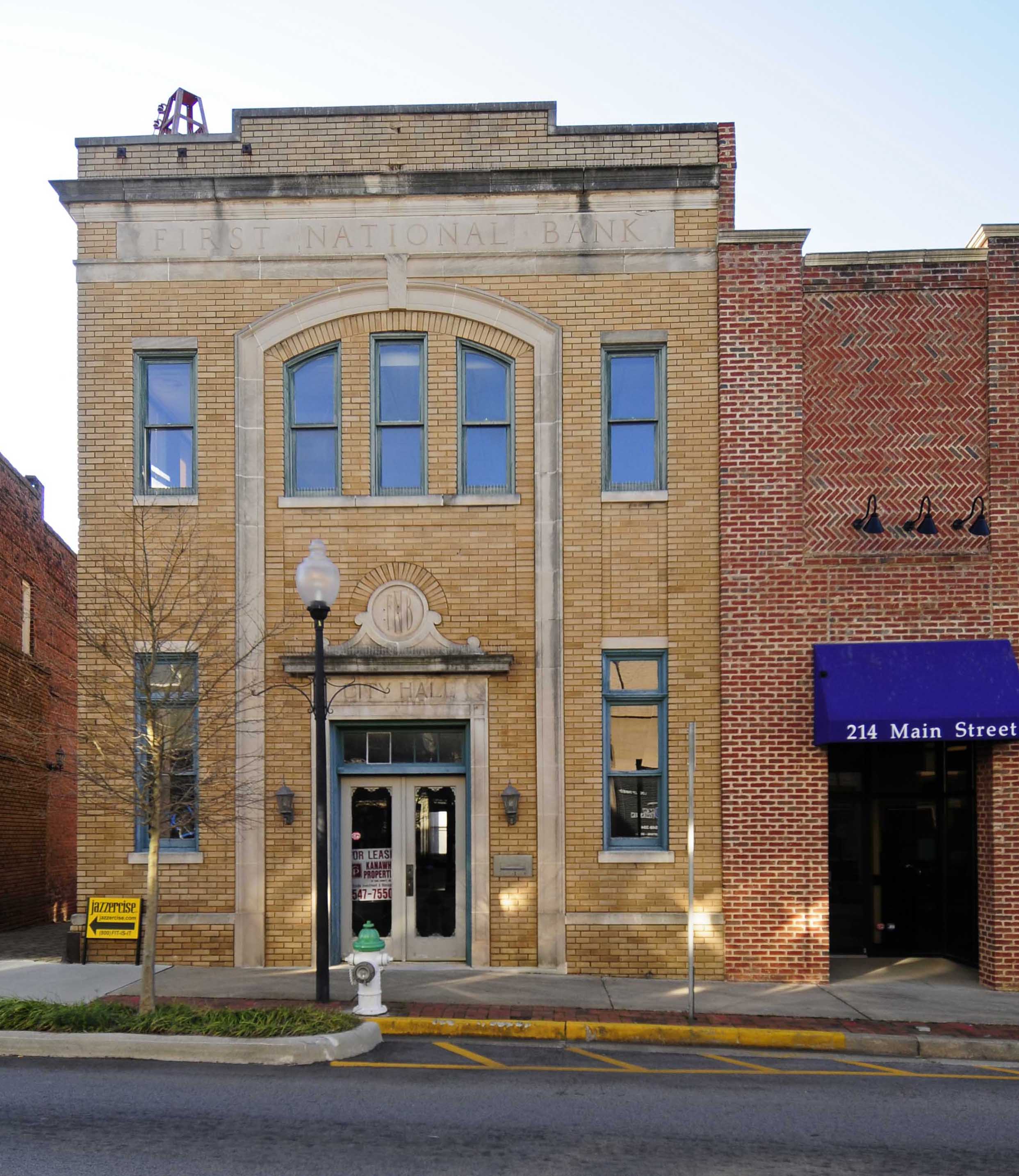 Historic brick storefronts and a street lamp along Fort Mill's downtown Main Street.