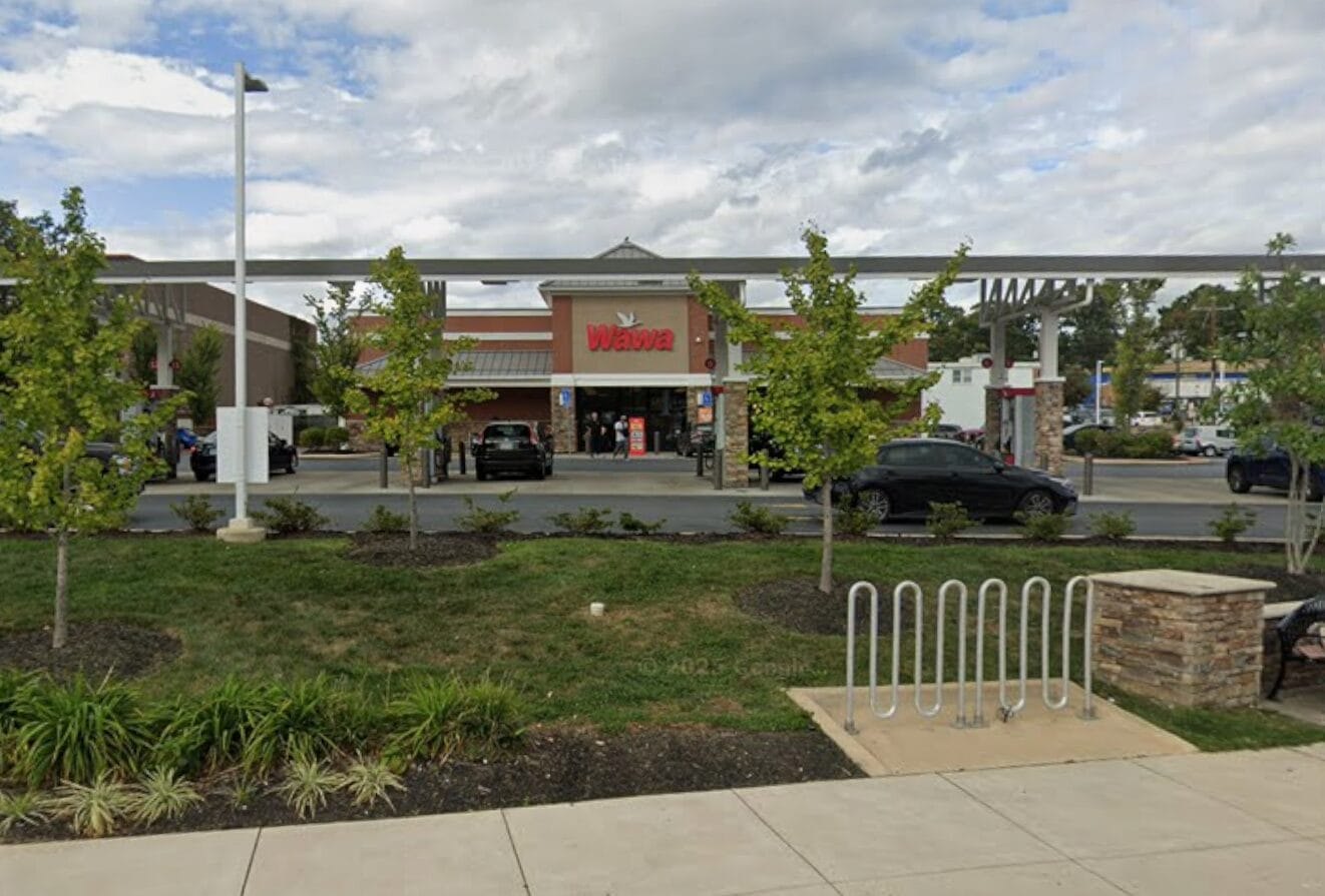 Wawa convenience store with gas station canopy, parking lot, and landscaping.