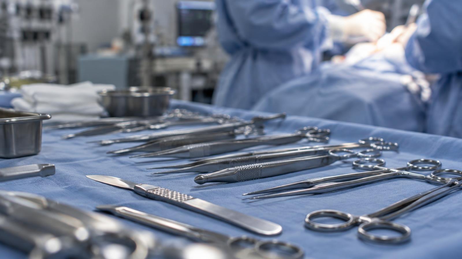 Stainless steel surgical instruments arranged neatly on a sterile blue drape.