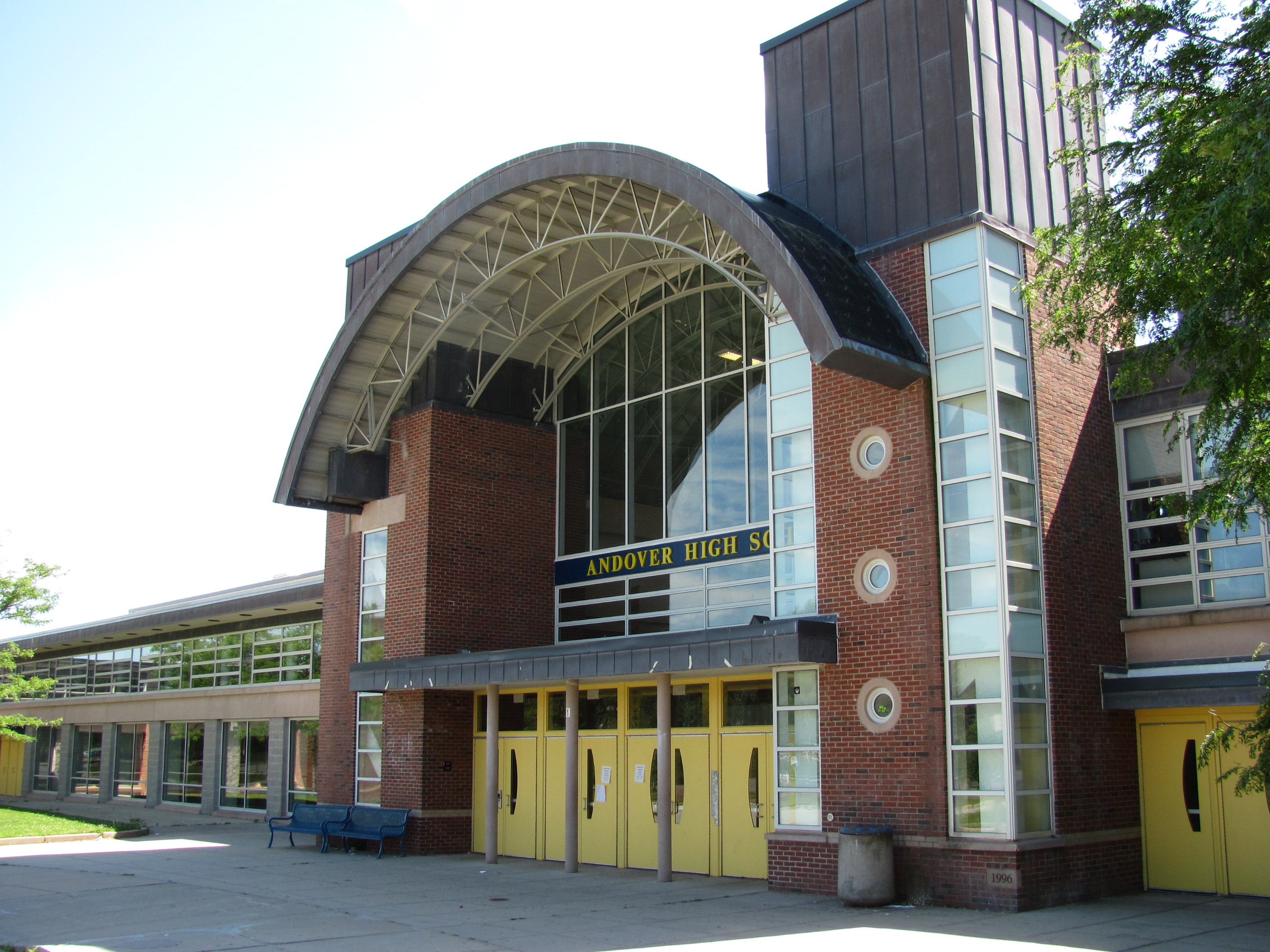 Entrance to Andover High School with arched canopy and brick facade.