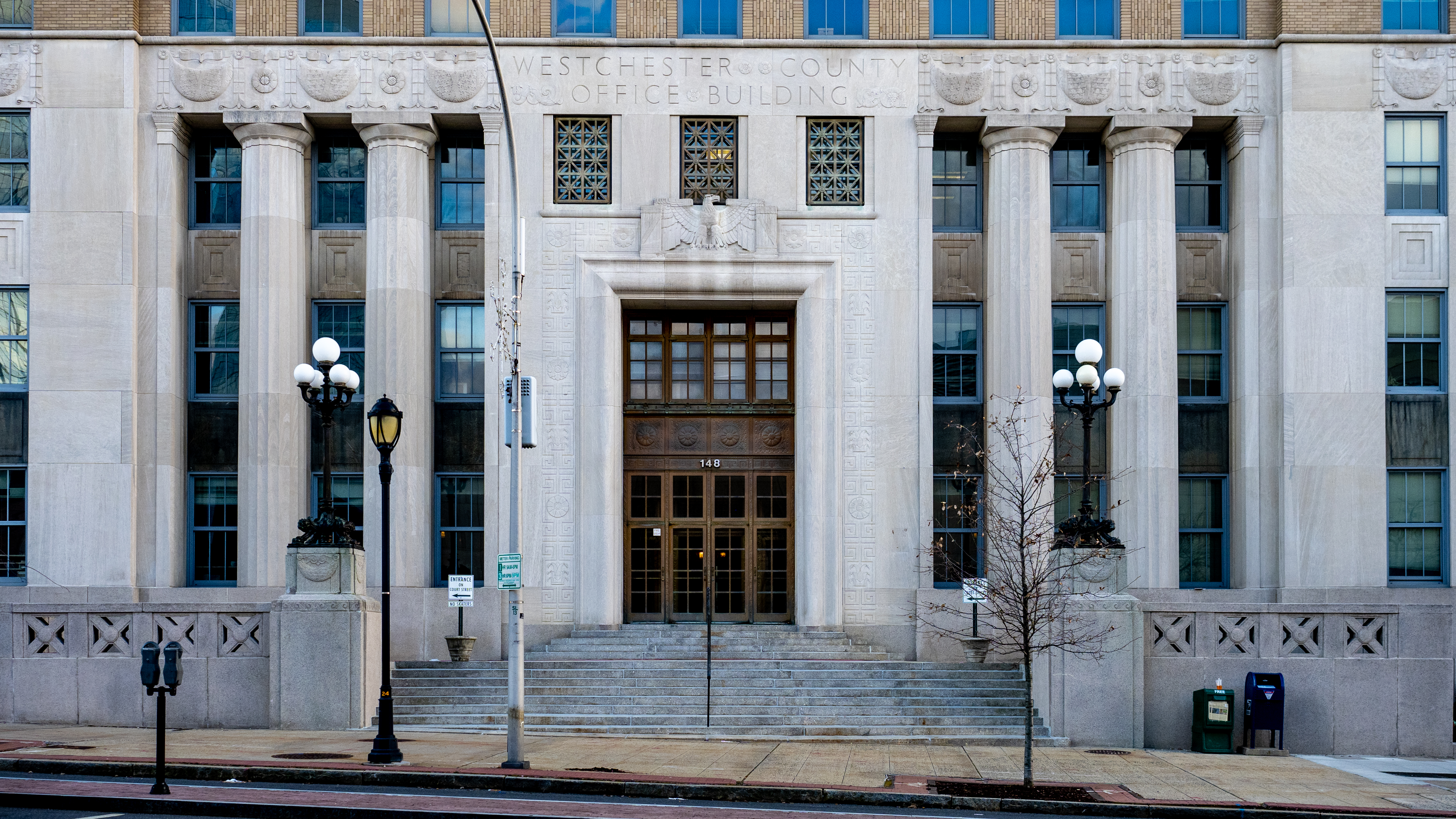 Neoclassical government building with tall stone columns and wide entrance steps.