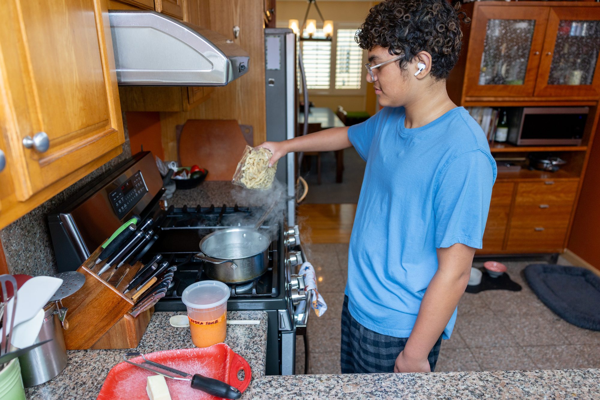 Teen Cooking for Himself in a Kitchen