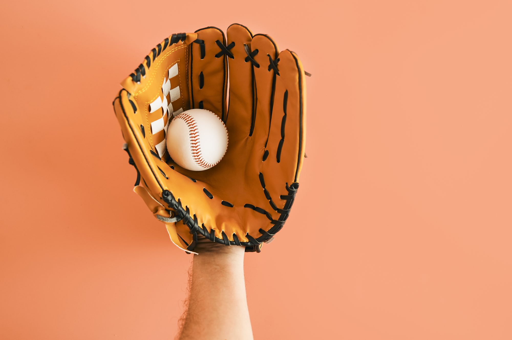Close-up of hand with baseball glove with ball