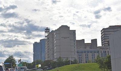 Hotels including Courtyard by Marriott and DoubleTree in a commercial area under cloudy skies.