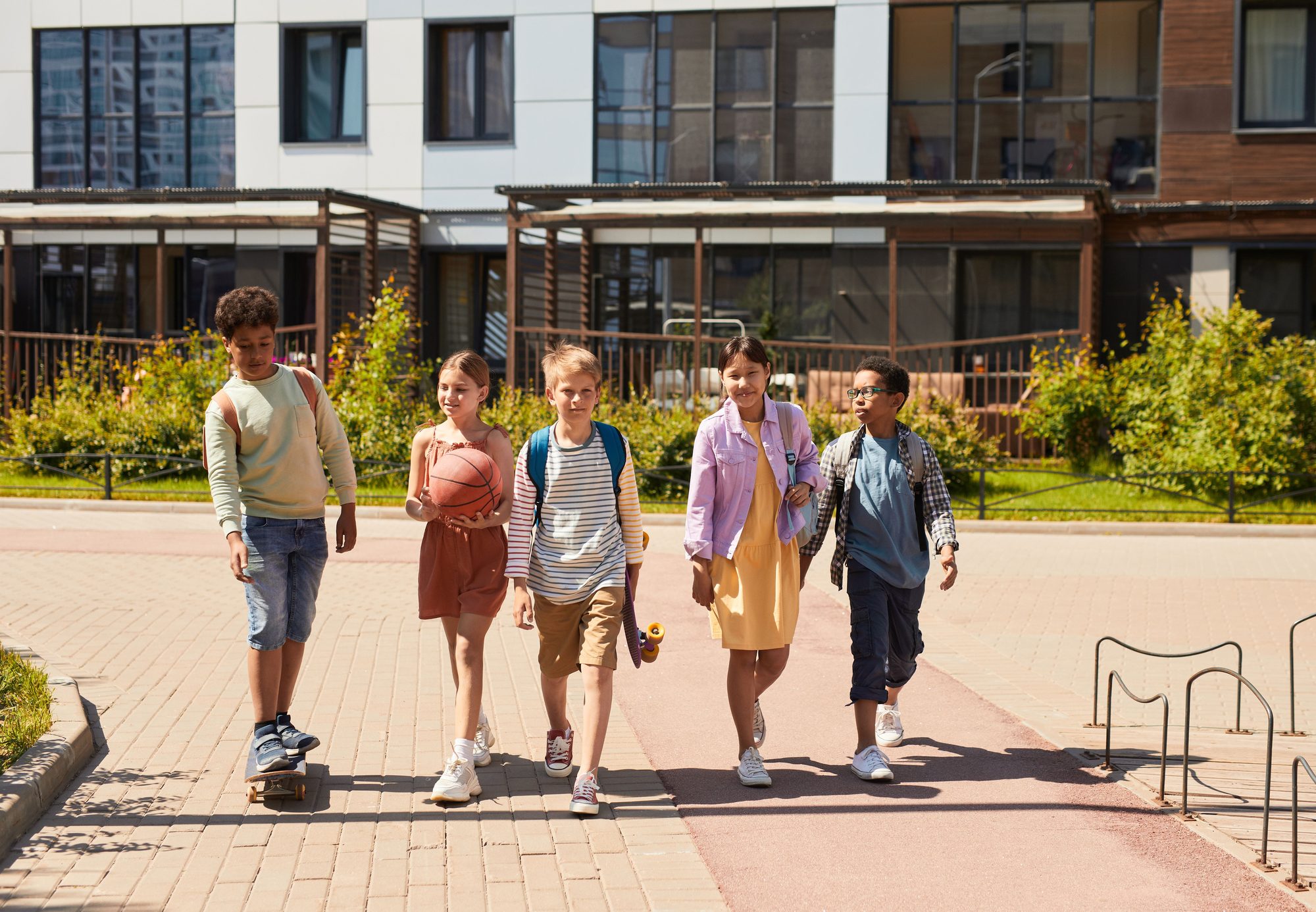 A diverse group of children walking outdoors, symbolizing friendship and multicultural unity.
