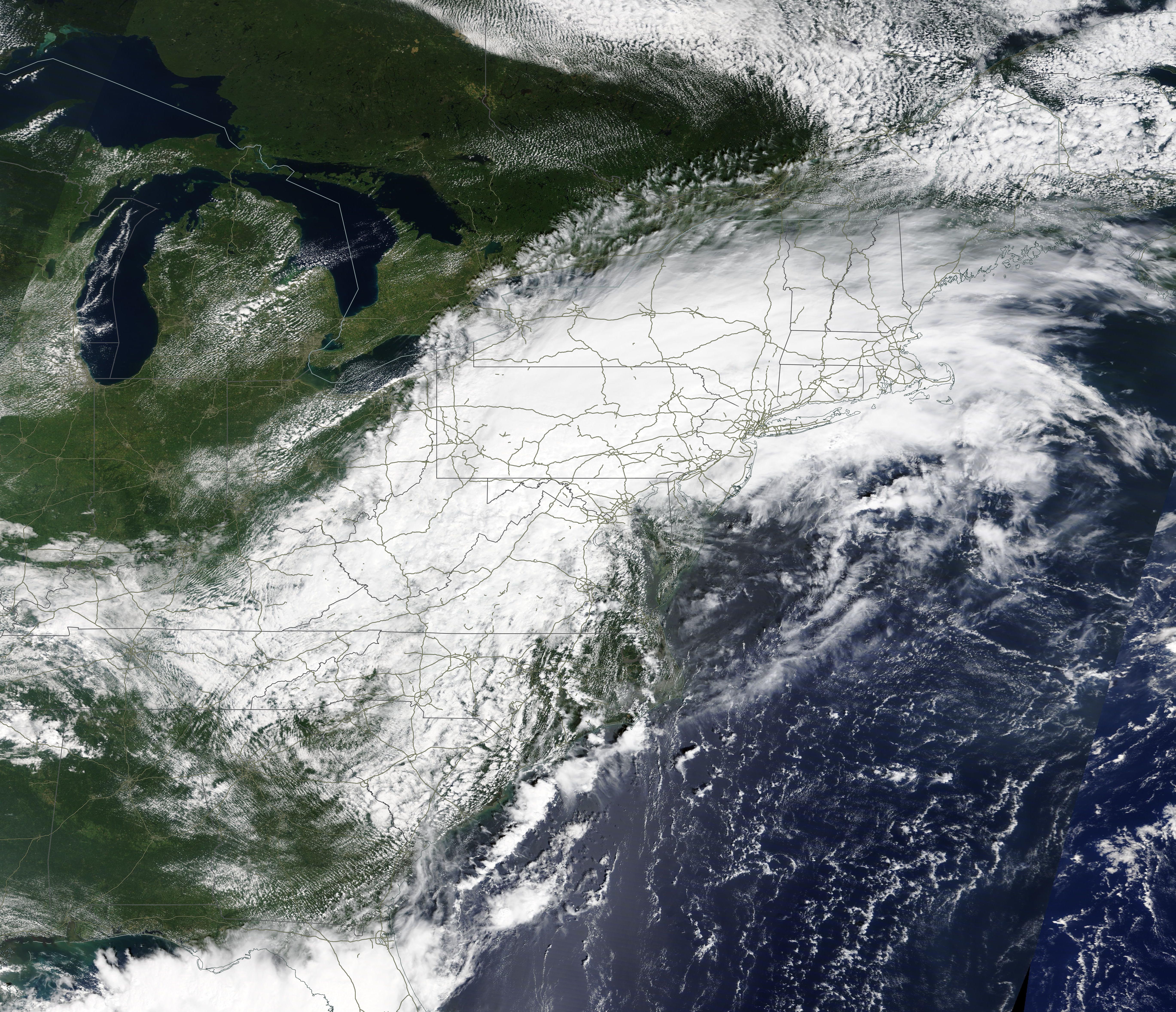 Satellite view of dense cloud cover from a storm system over the northeastern United States.