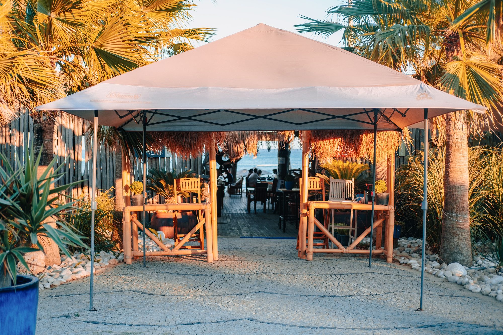 Relax under the sunshade at a luxurious tropical beachfront resort patio.