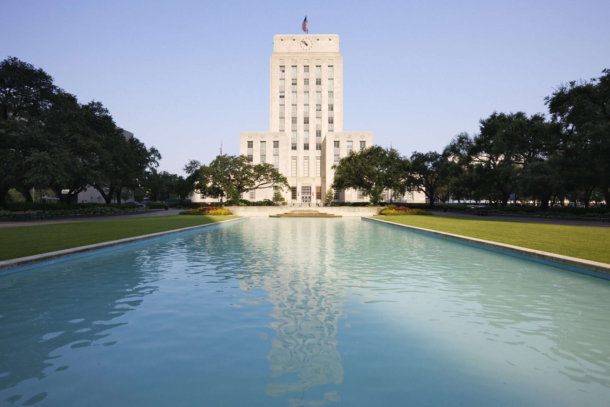 Houston City Hall over pond in urban park, Houston, Texas, United States