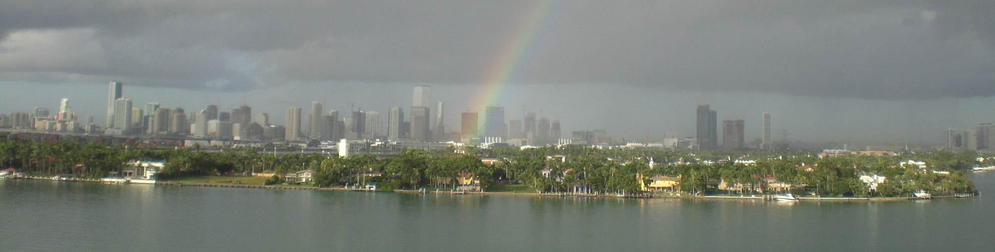 Panoramic view of Star Island's waterfront estates with the Miami skyline beyond.
