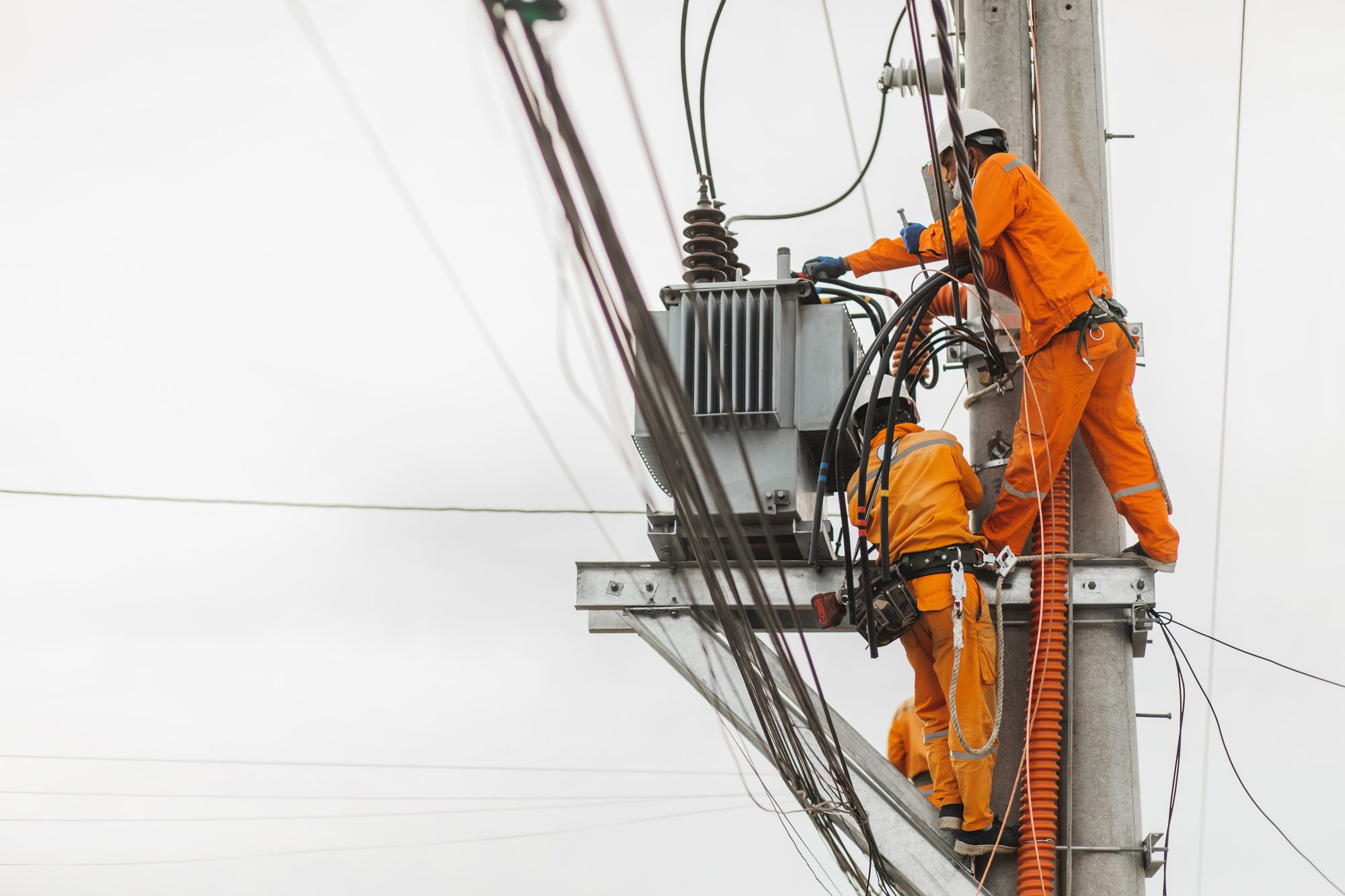 Electric Line Workers Performing Maintenance on Powerpole