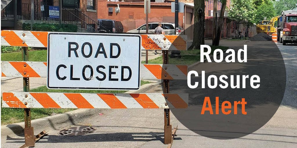Orange and white road closed barricade with a Road Closure Alert graphic overlay.