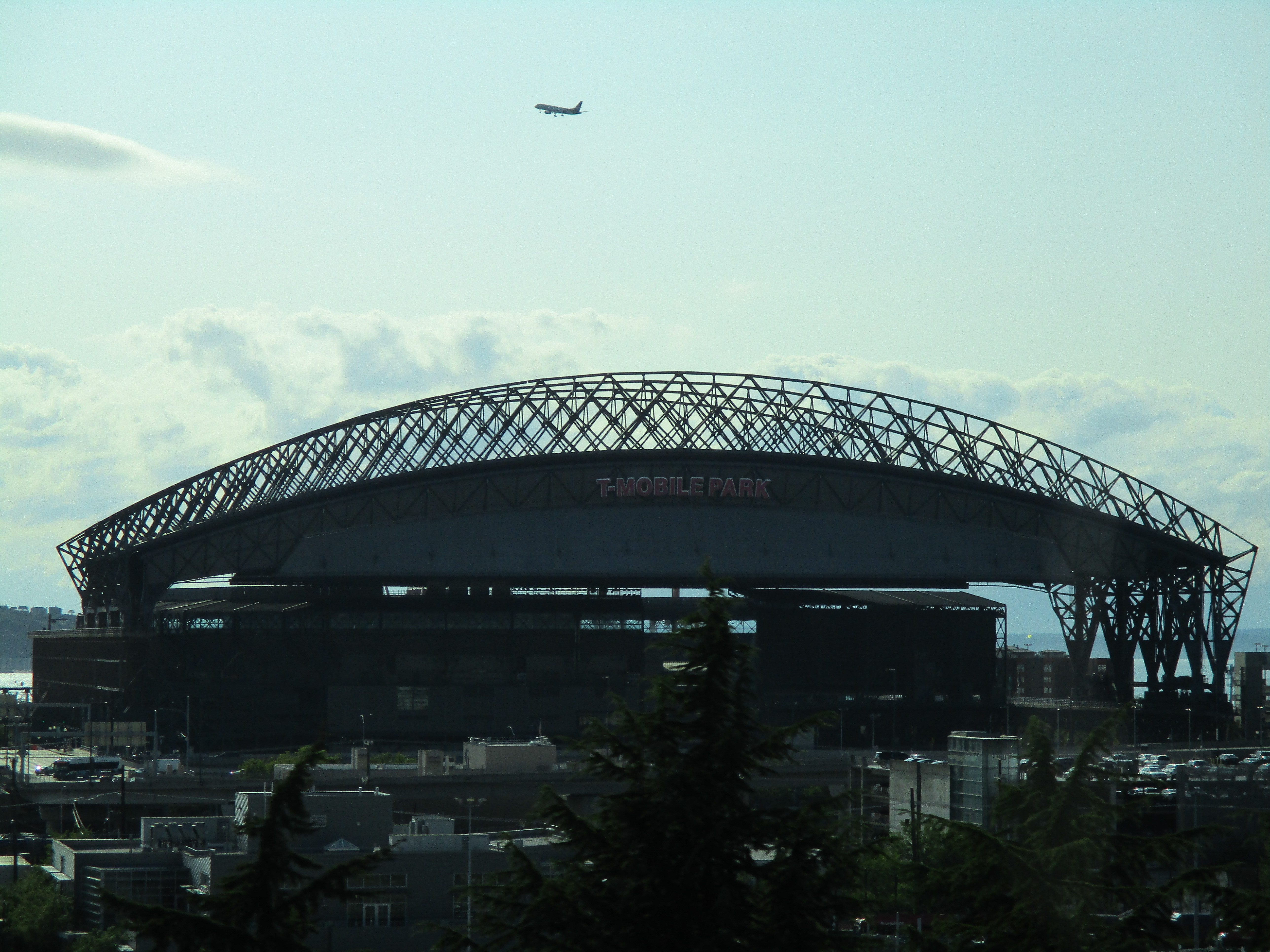 Exterior of T-Mobile Park stadium with arched steel roof and signage.