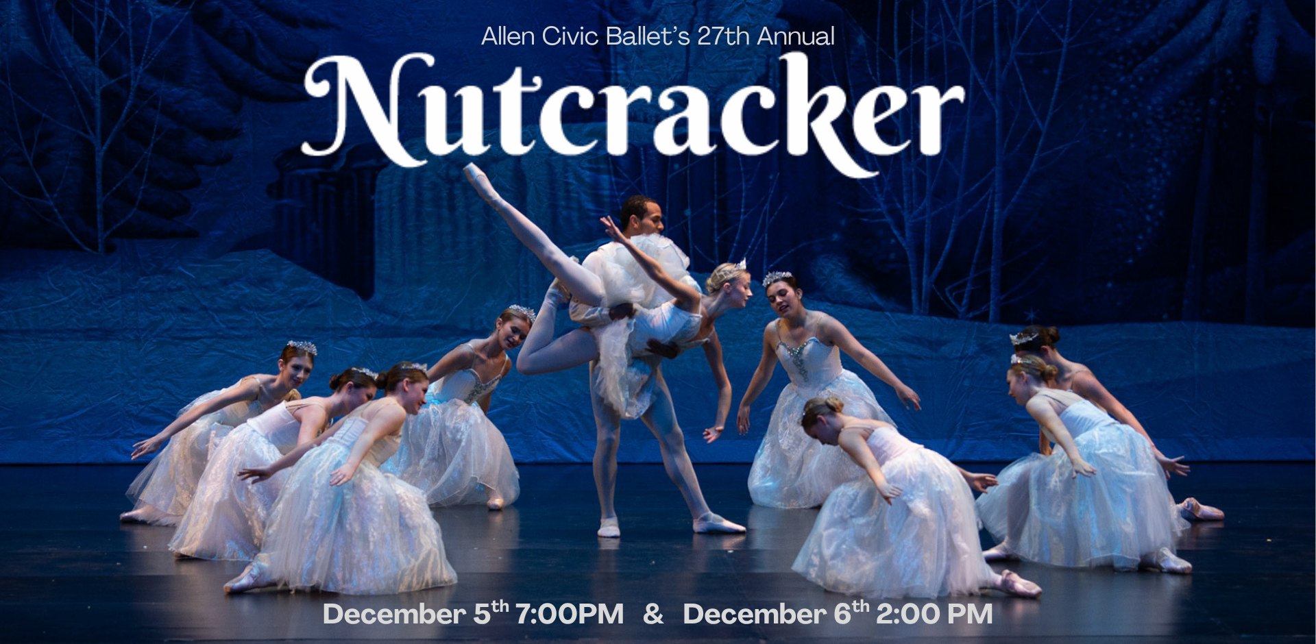 Ballet dancers in white tutus perform on a stage with a blue winter forest backdrop.
