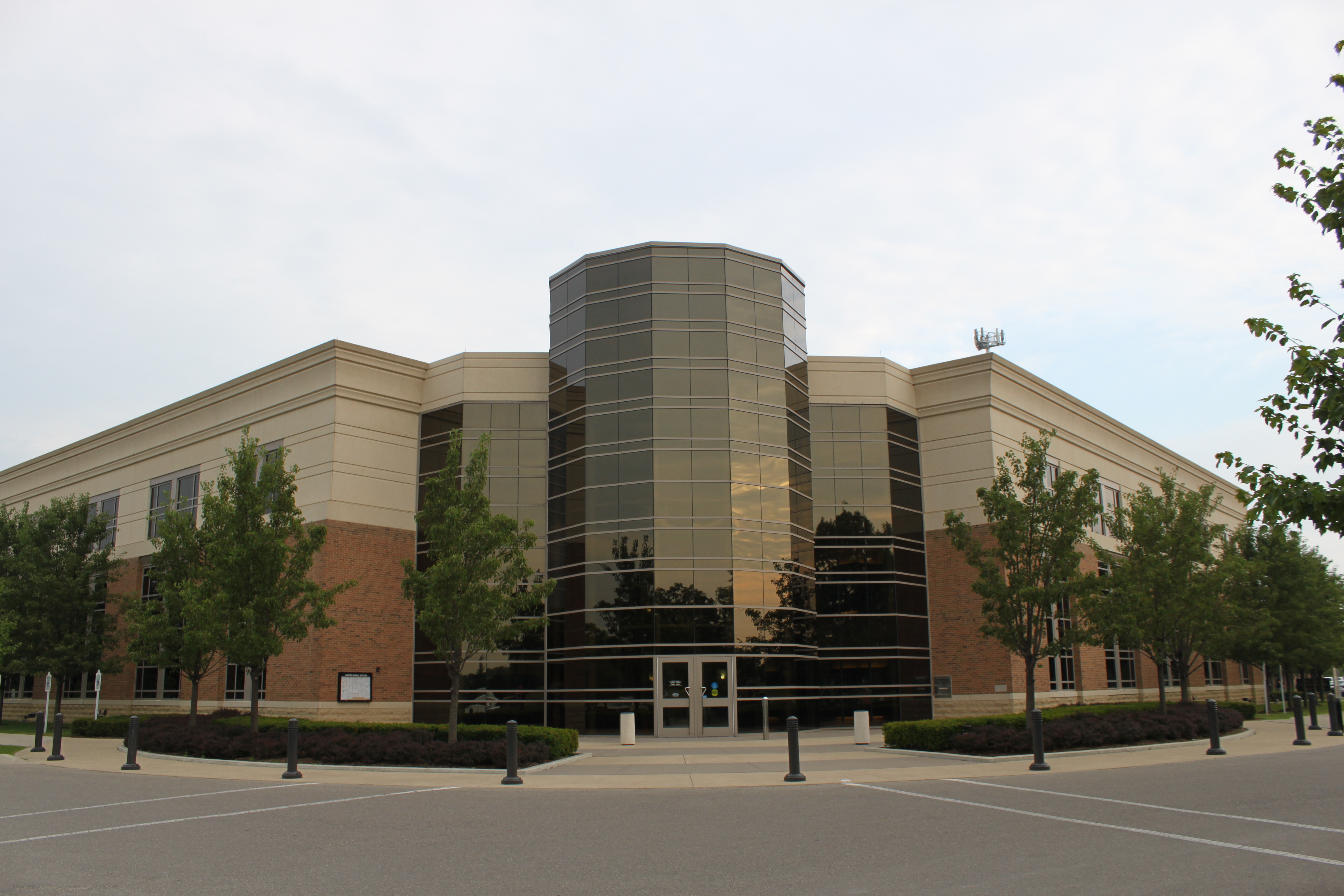 Two-story brick and glass township municipal building with octagonal glass entrance tower.