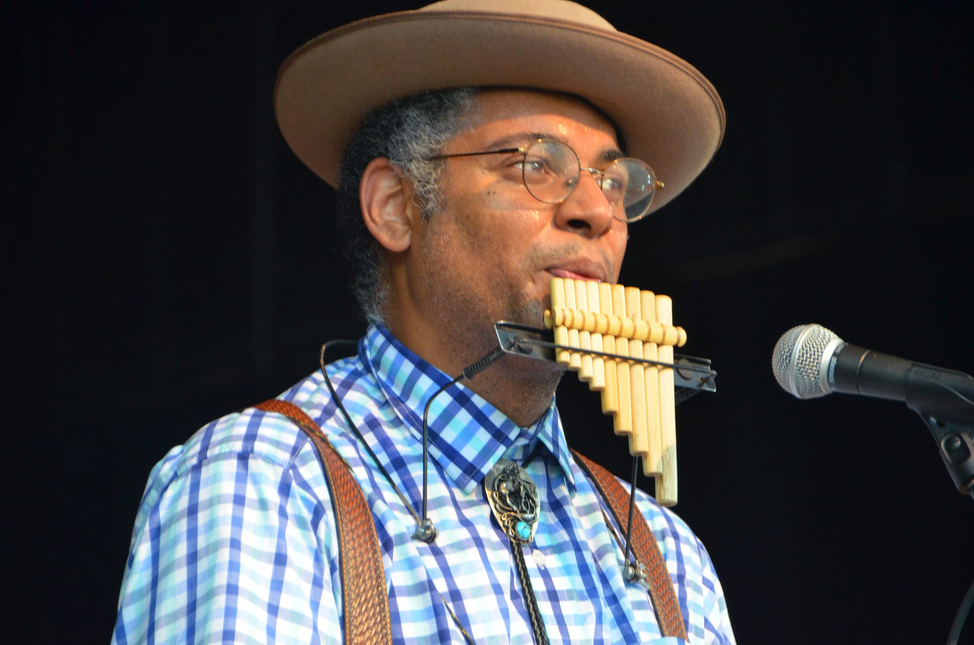 Dom Flemons demonstrates the pipes at the 2019 Philadelphia Folk Festival