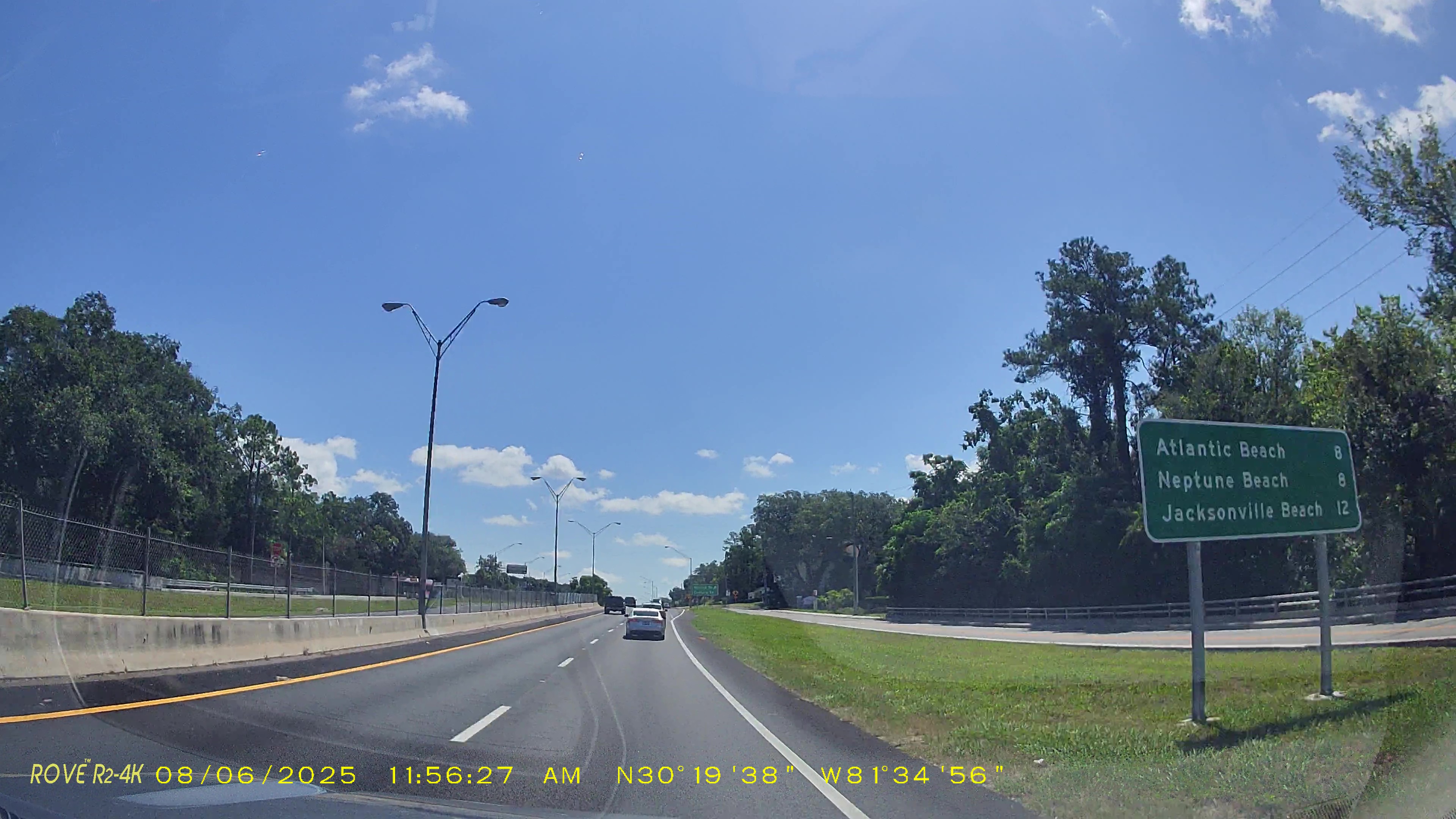 Green highway distance sign showing miles to Atlantic Beach, Neptune Beach, and Jacksonville Beach.
