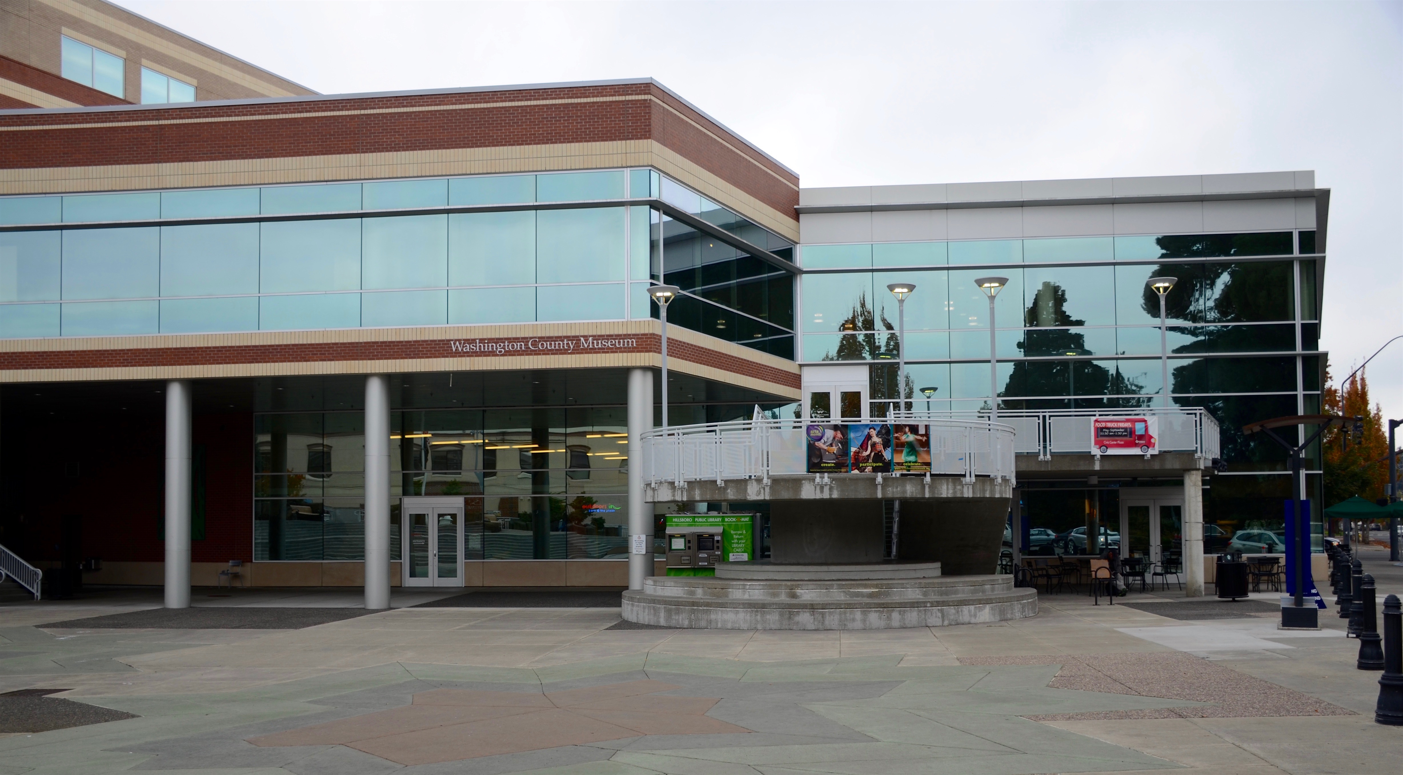 Glass and brick municipal building at the Hillsboro Civic Center, viewed from a public plaza.