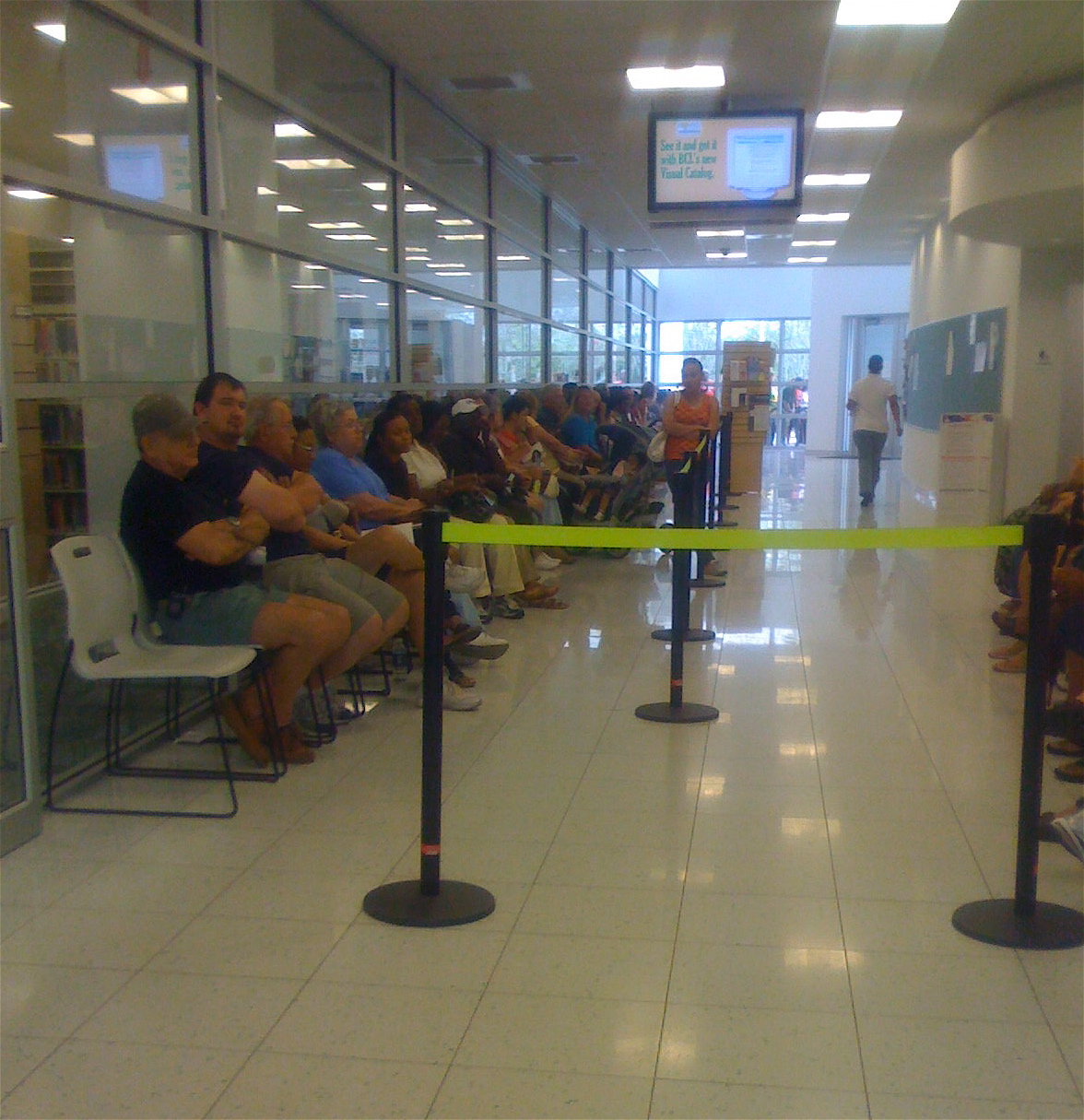A long line of voters waiting inside a polling place during early voting.