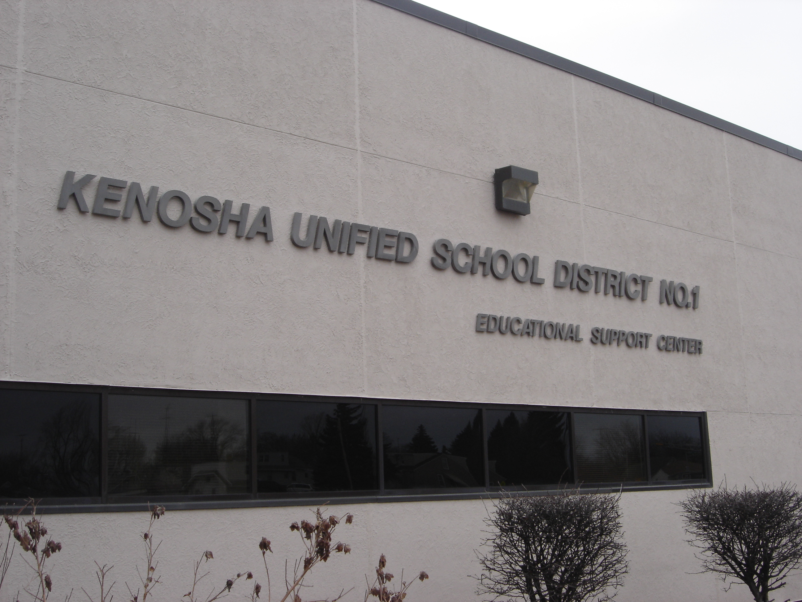 Exterior wall of a building with large mounted letters reading Kenosha Unified School District.