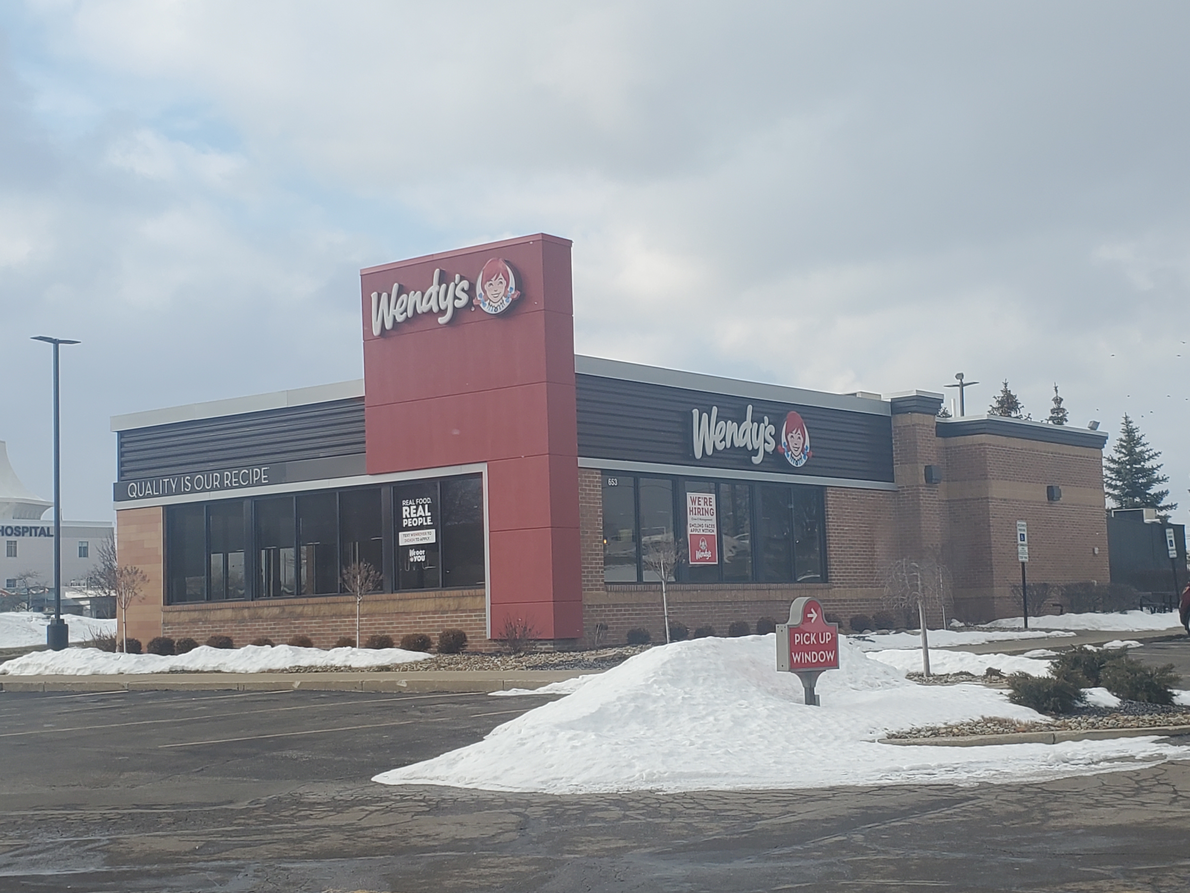 Exterior of a Wendy's fast food restaurant with red signage.