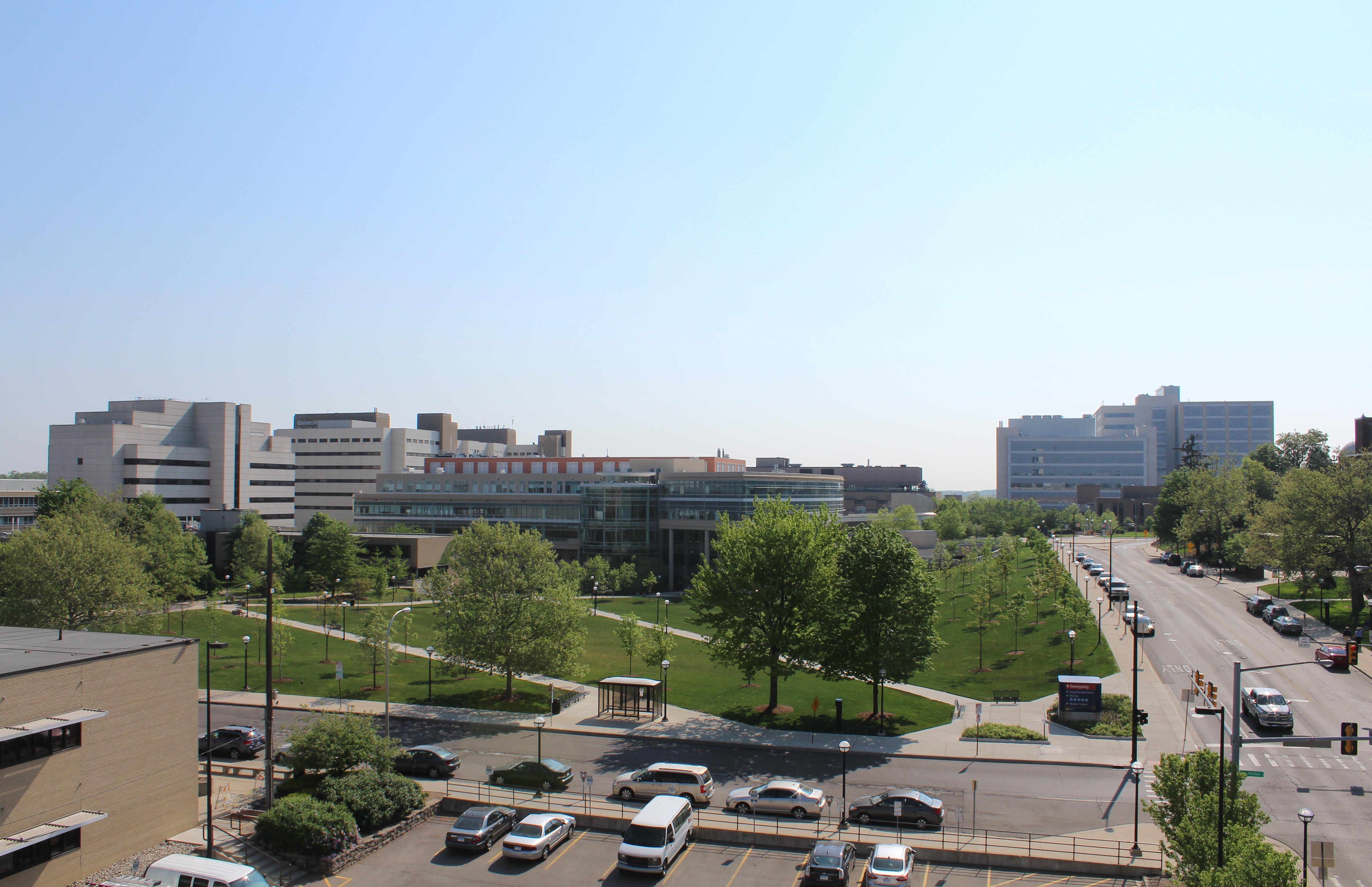 Aerial view of a large university medical campus with hospital buildings, lawns, and parking lots.