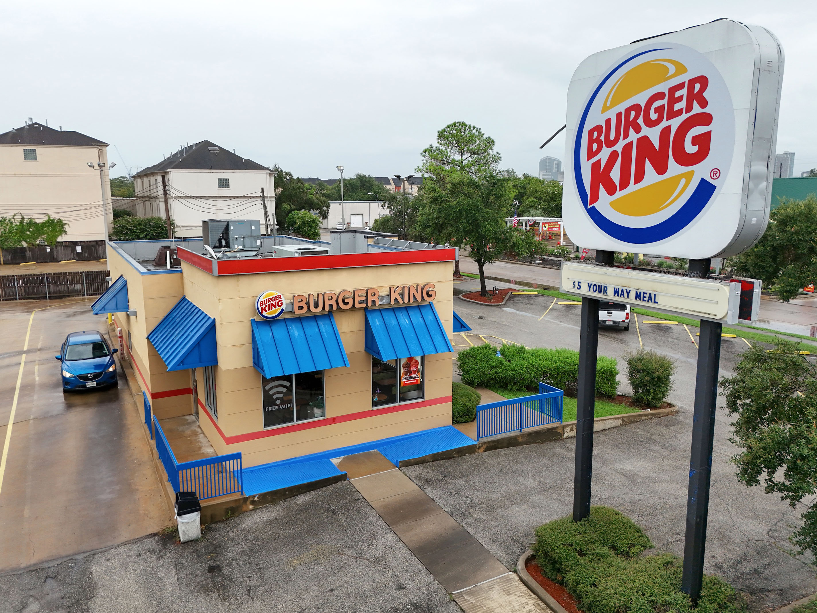 Elevated view of a Burger King restaurant with drive-through lane and pole sign.
