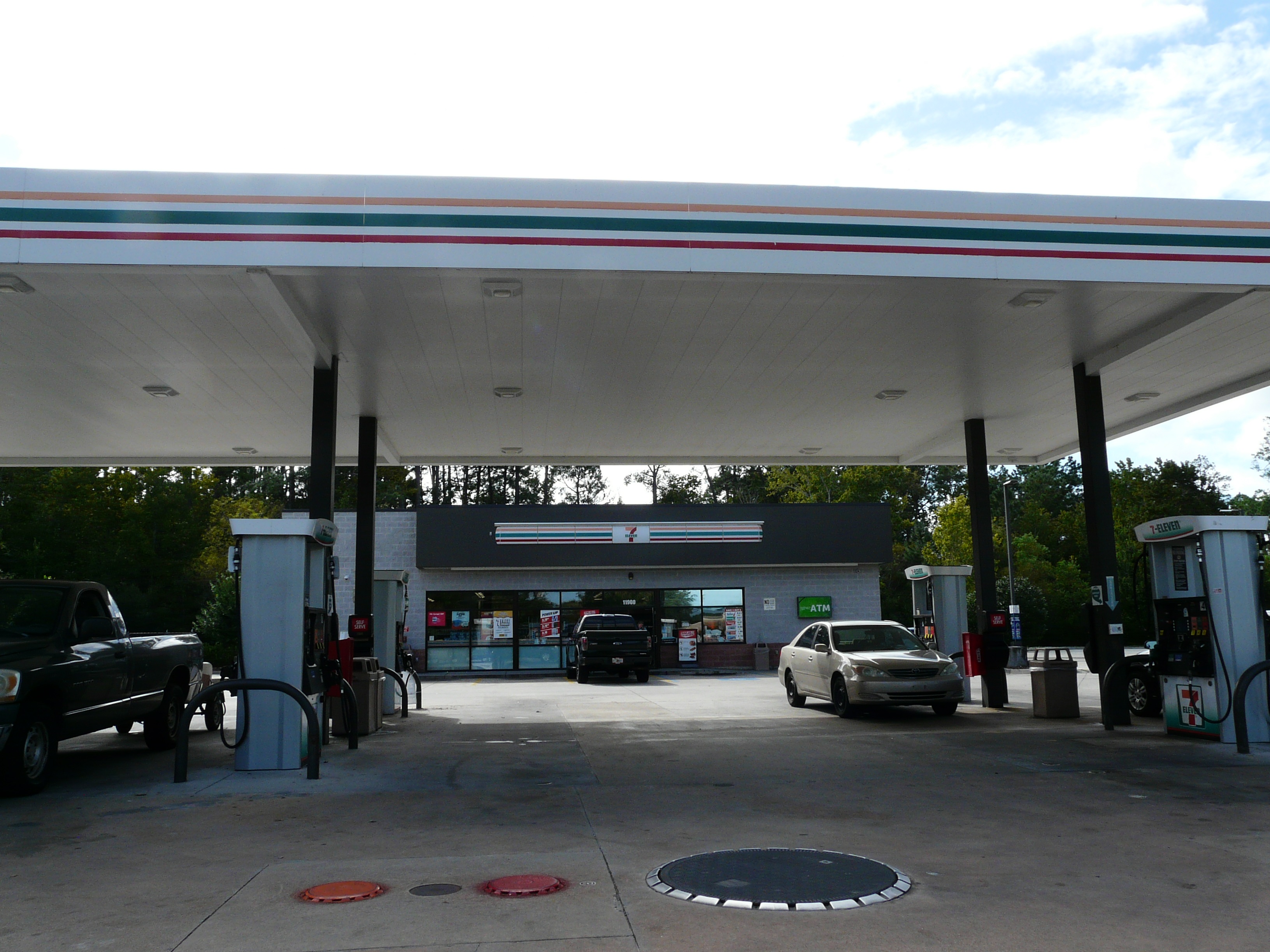 Illustrative photo of a 7-Eleven convenience store and fuel canopy; the proposed Curley Road site has not been built.