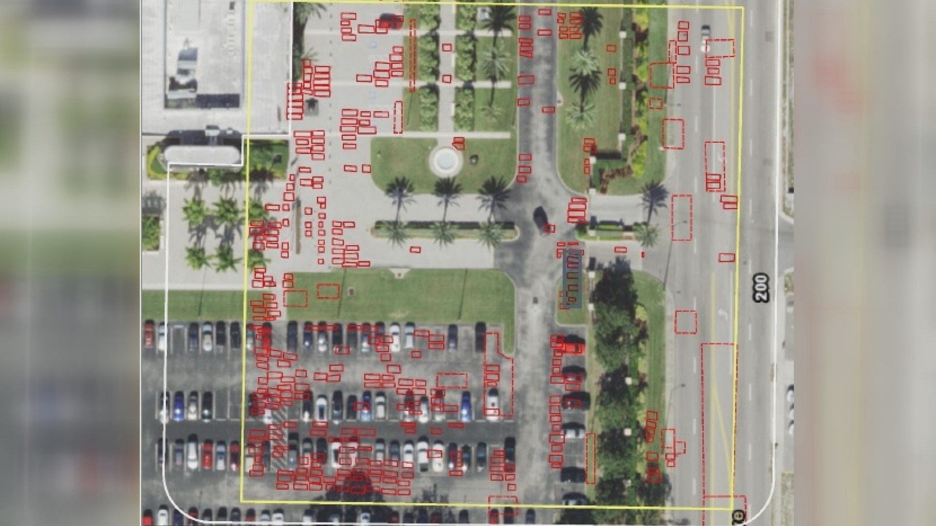 Aerial view of a property with red rectangular boxes overlaid, marking detected underground anomalies.