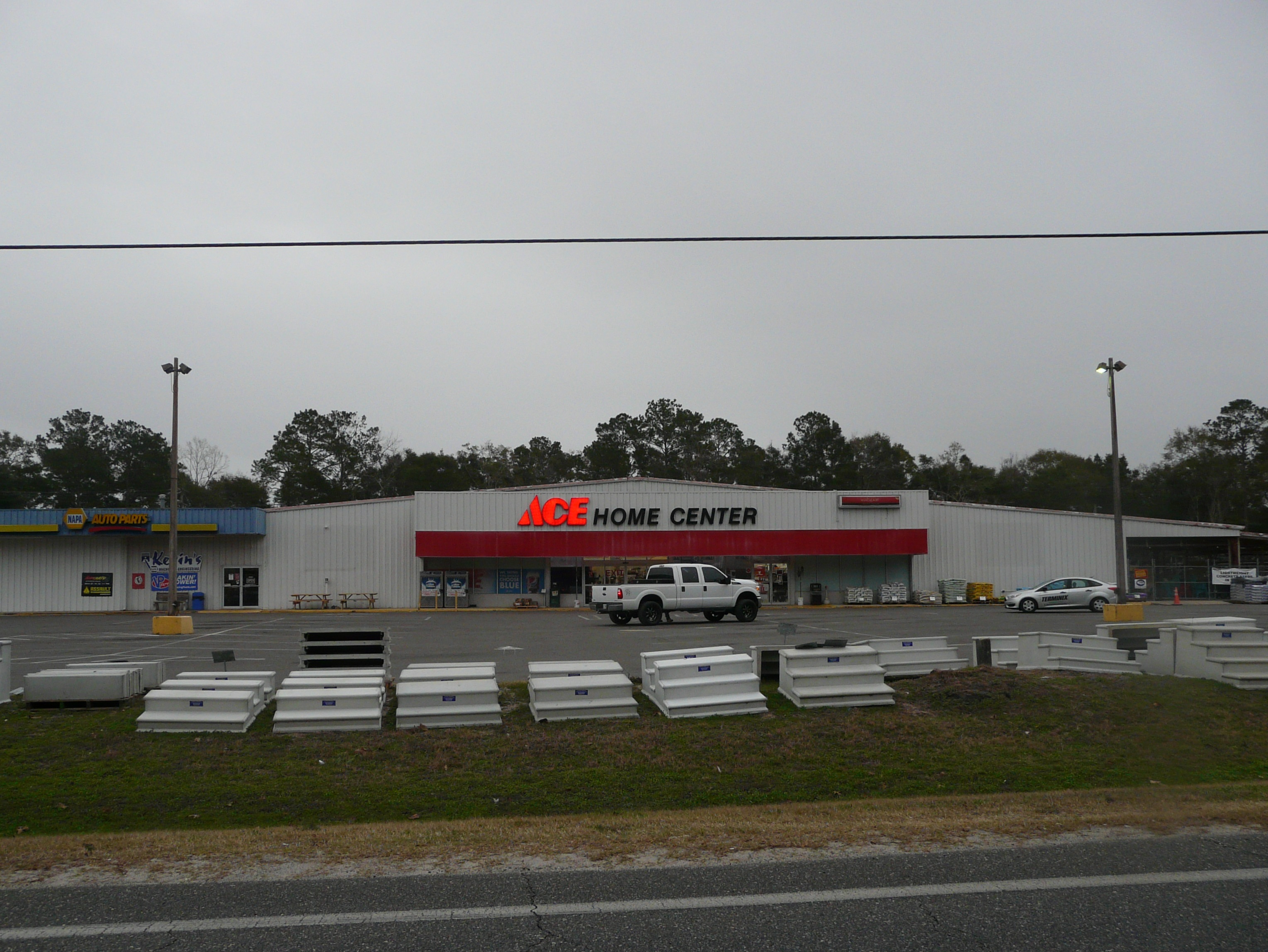 Single-story Ace Hardware store with red-and-white facade and a parking lot.