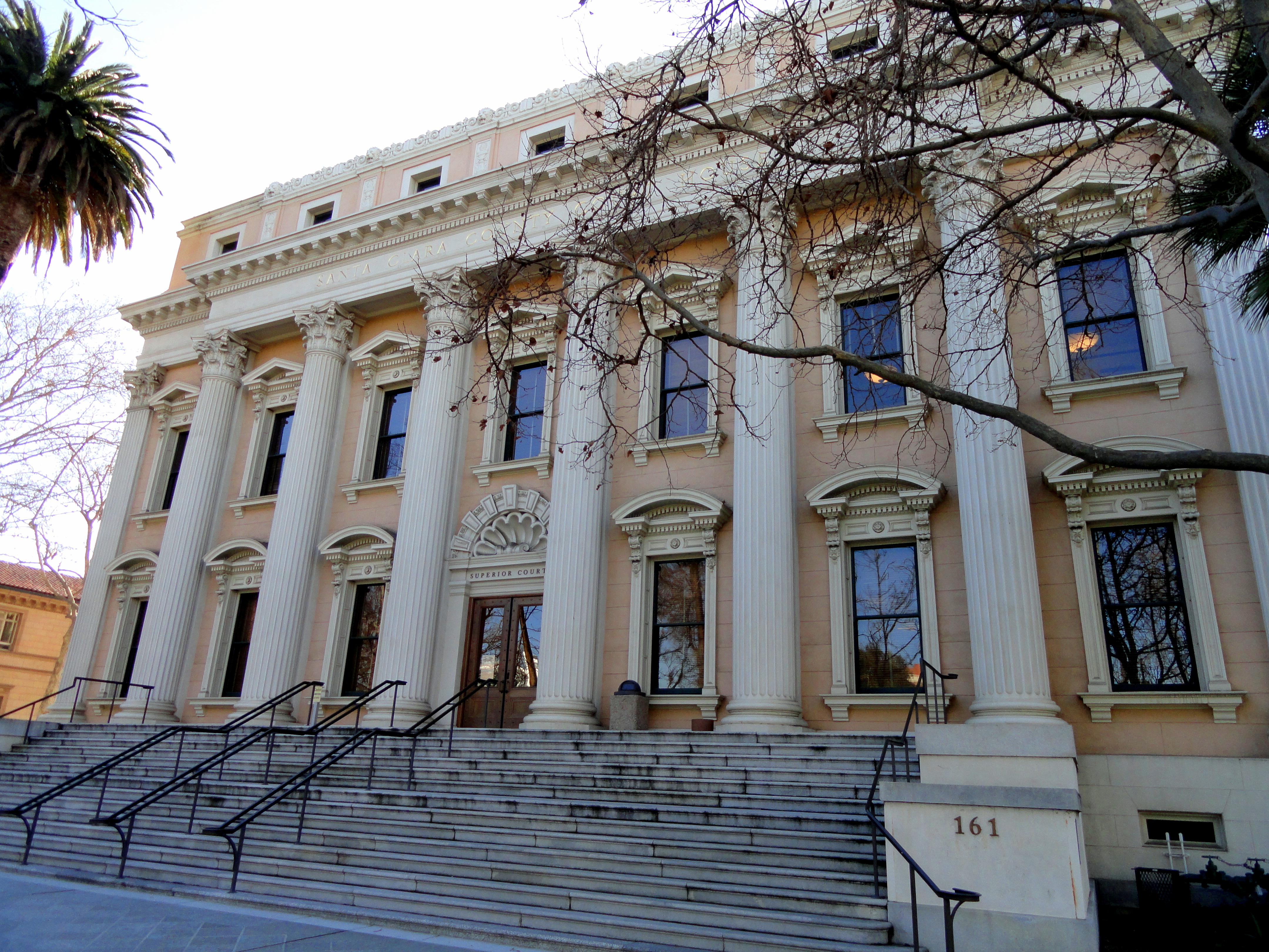 Neoclassical courthouse with tall white columns and wide stone steps.