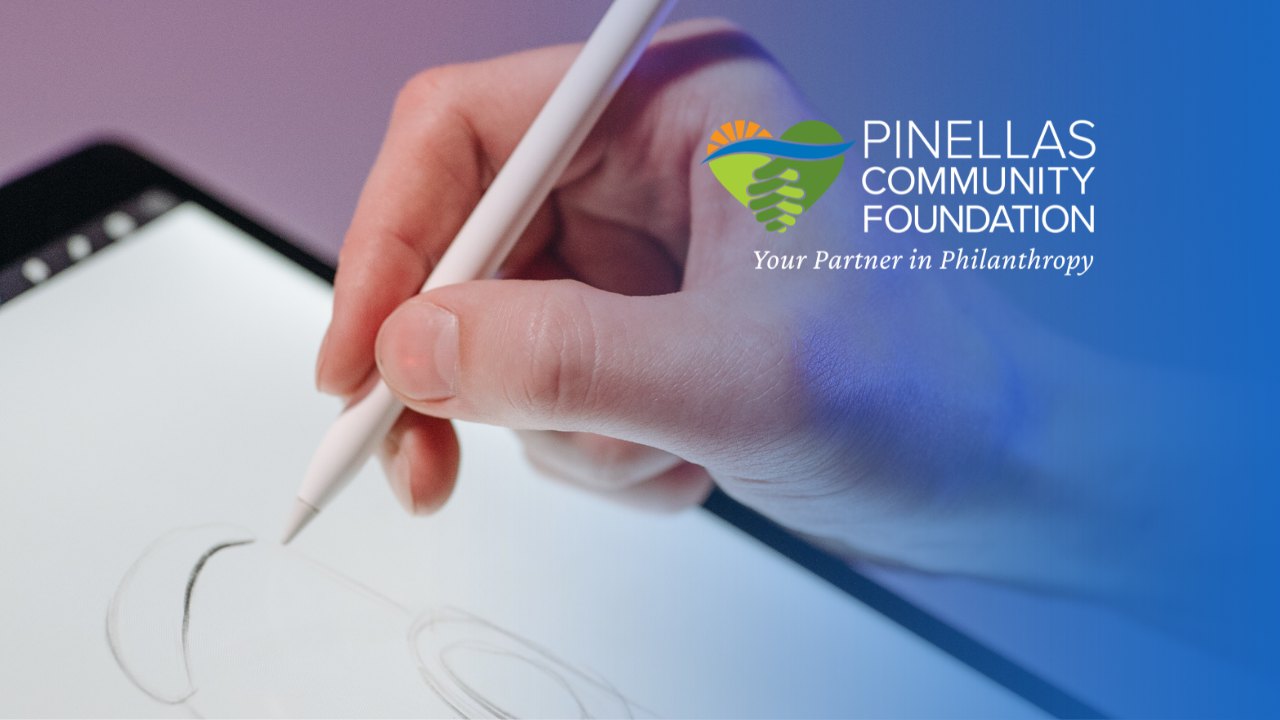 A hand holding an Apple Pencil drawing on a tablet screen.