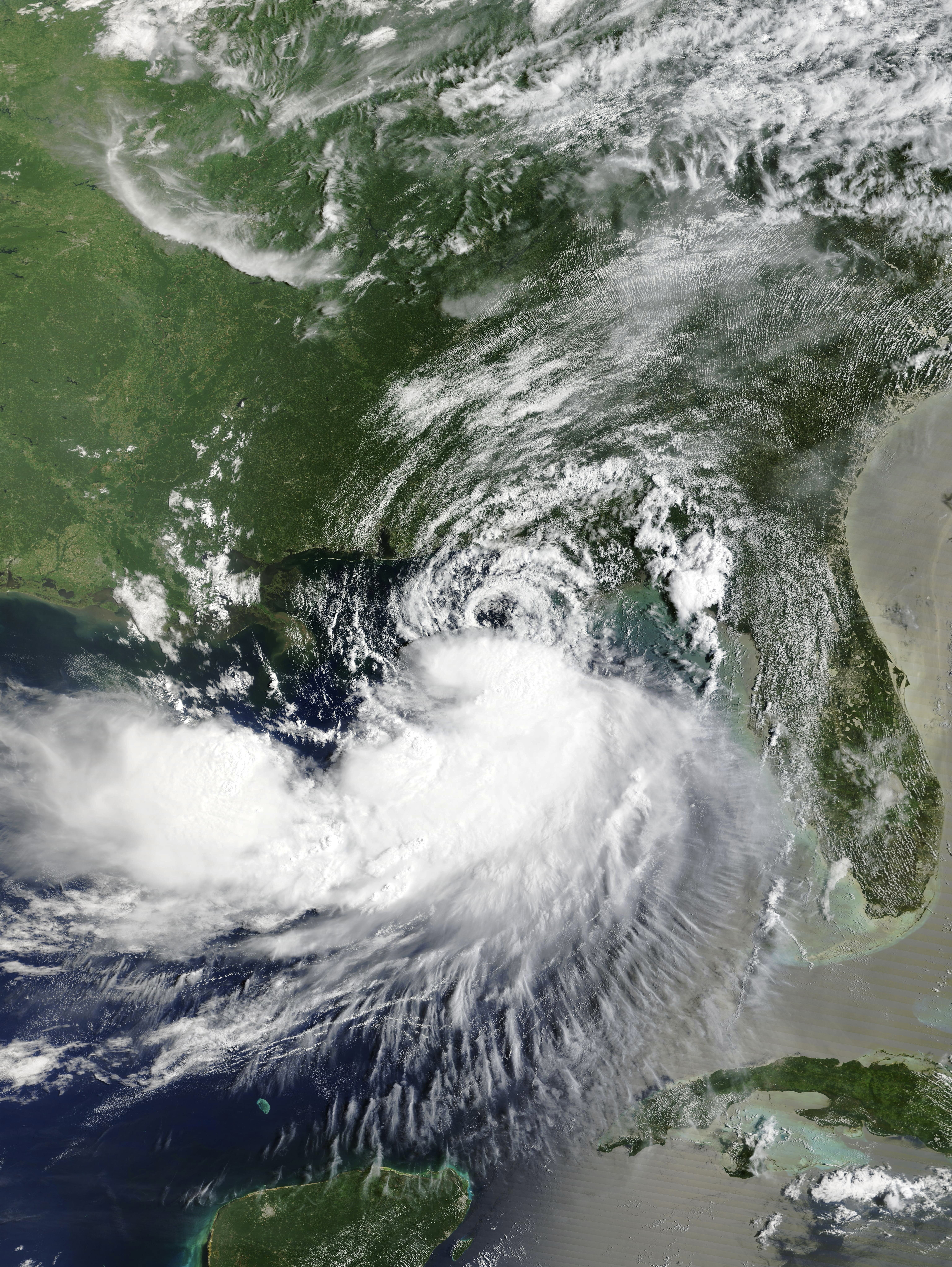 Satellite image of a tropical storm's swirling cloud bands over the Gulf of Mexico.