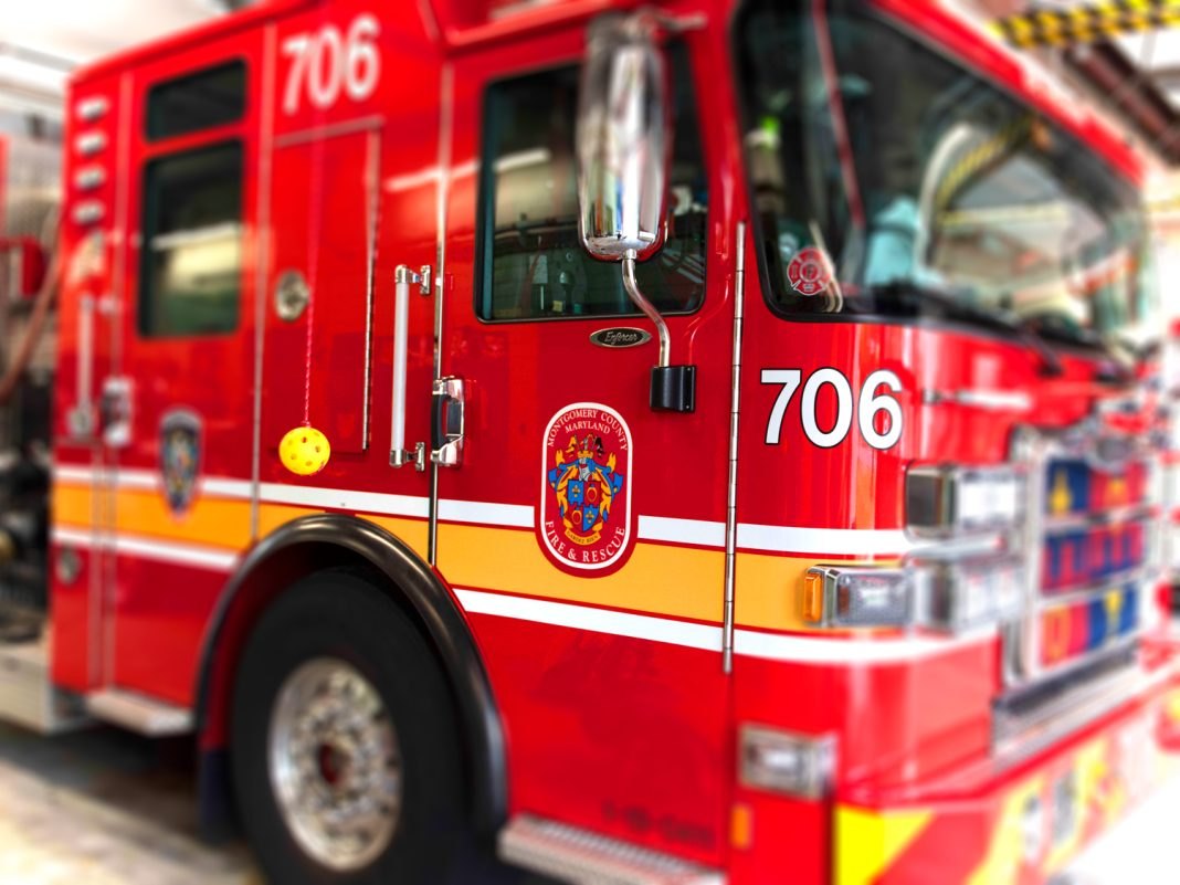 Red Montgomery County fire truck numbered 706 parked inside a fire station bay.