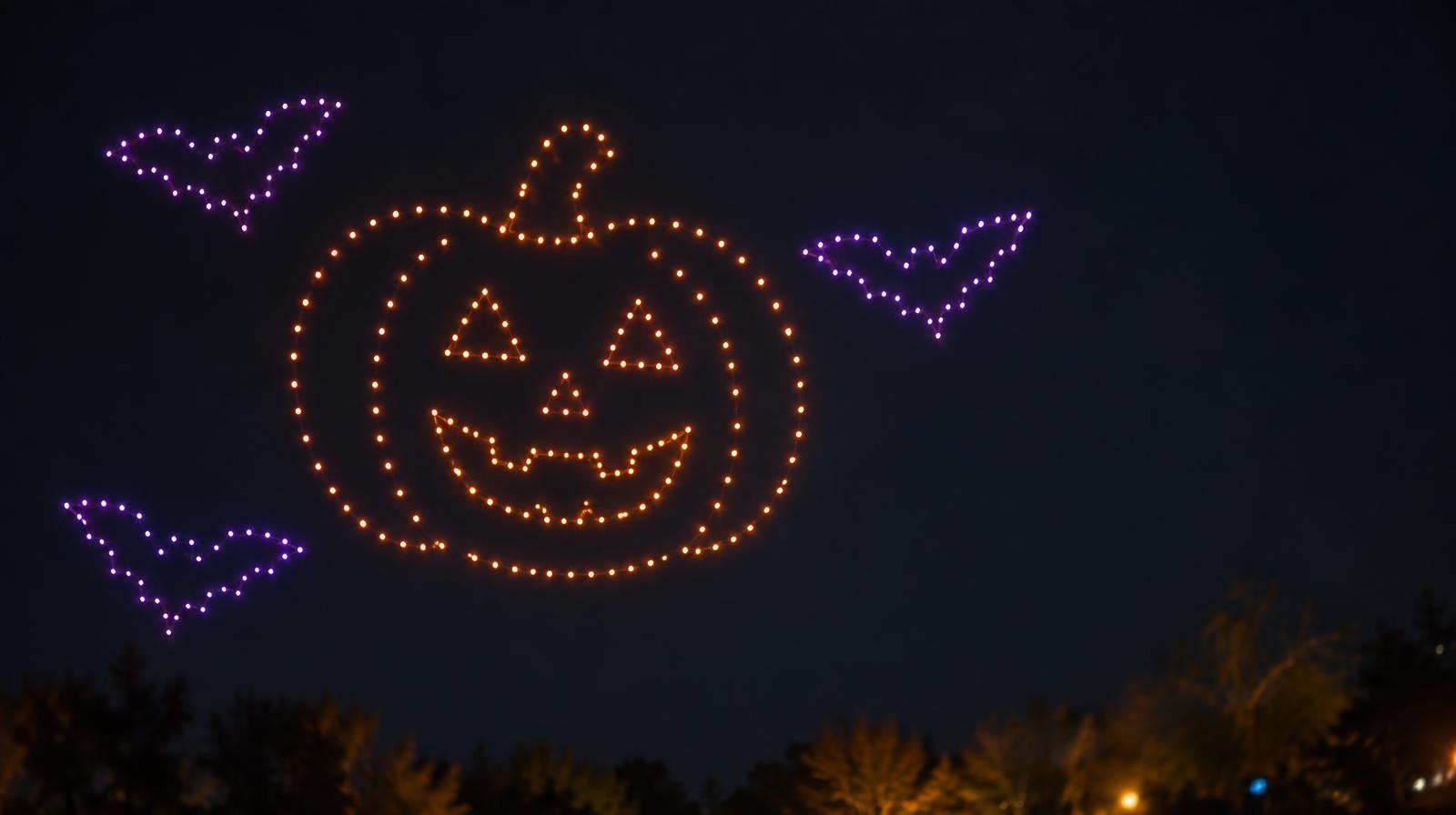 Glowing drones in orange and purple form a pattern against a dark night sky.